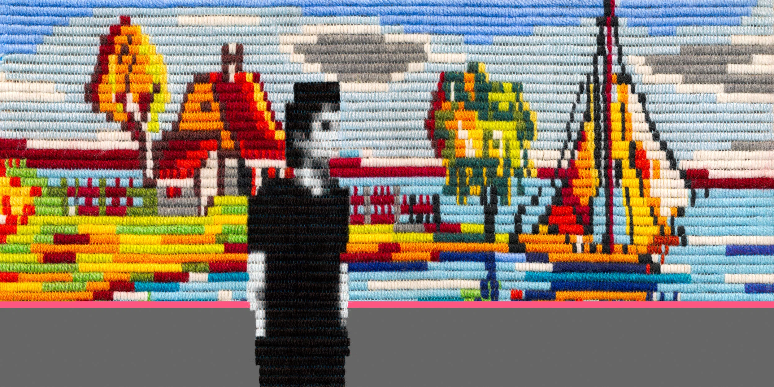 A person in black clothing standing in front of a large, colorful street art mural made of beads depicting a lakeside scene with boats, trees, and buildings.