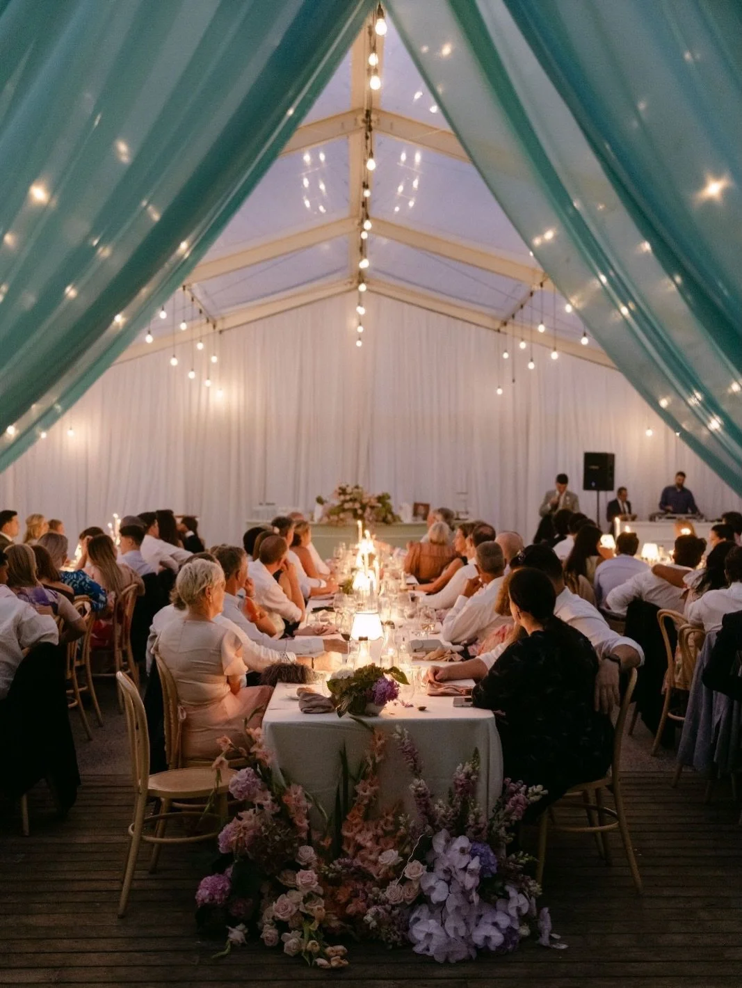 A refined garden celebration, where soft structure and thoughtful detail shaped every moment of the day.

From the movement of the aisle to a candlelit reception beneath a draped marquee, the design leaned into a palette of gentle pastels, layered fl