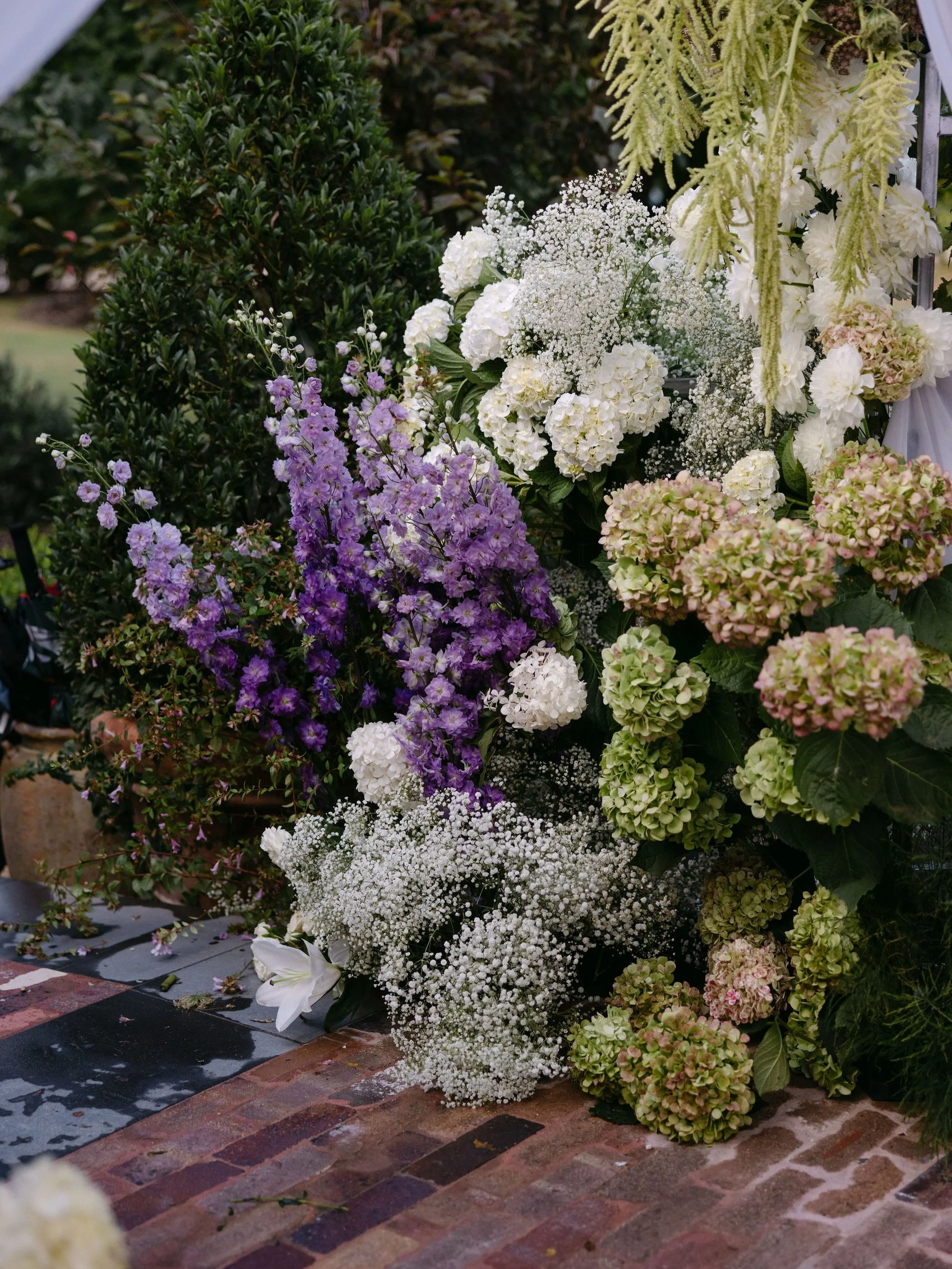 Garden party, but make it black tie. Layers of hydrangea, delphinium and soft summer greens, a champagne bar tucked beneath the marquee and playful details woven through the tablescape. 

Bride | @georgie_mayes 
Groom | @schmoobey
Venue | @redleafwol