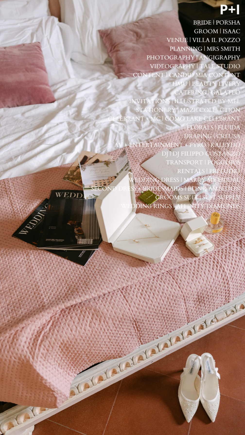 A hotel bed with white sheets and two pink pillows, a pink textured bedspread, and wedding accessories including jewelry, wedding magazines, and a pair of white wedding shoes arranged on the bed.