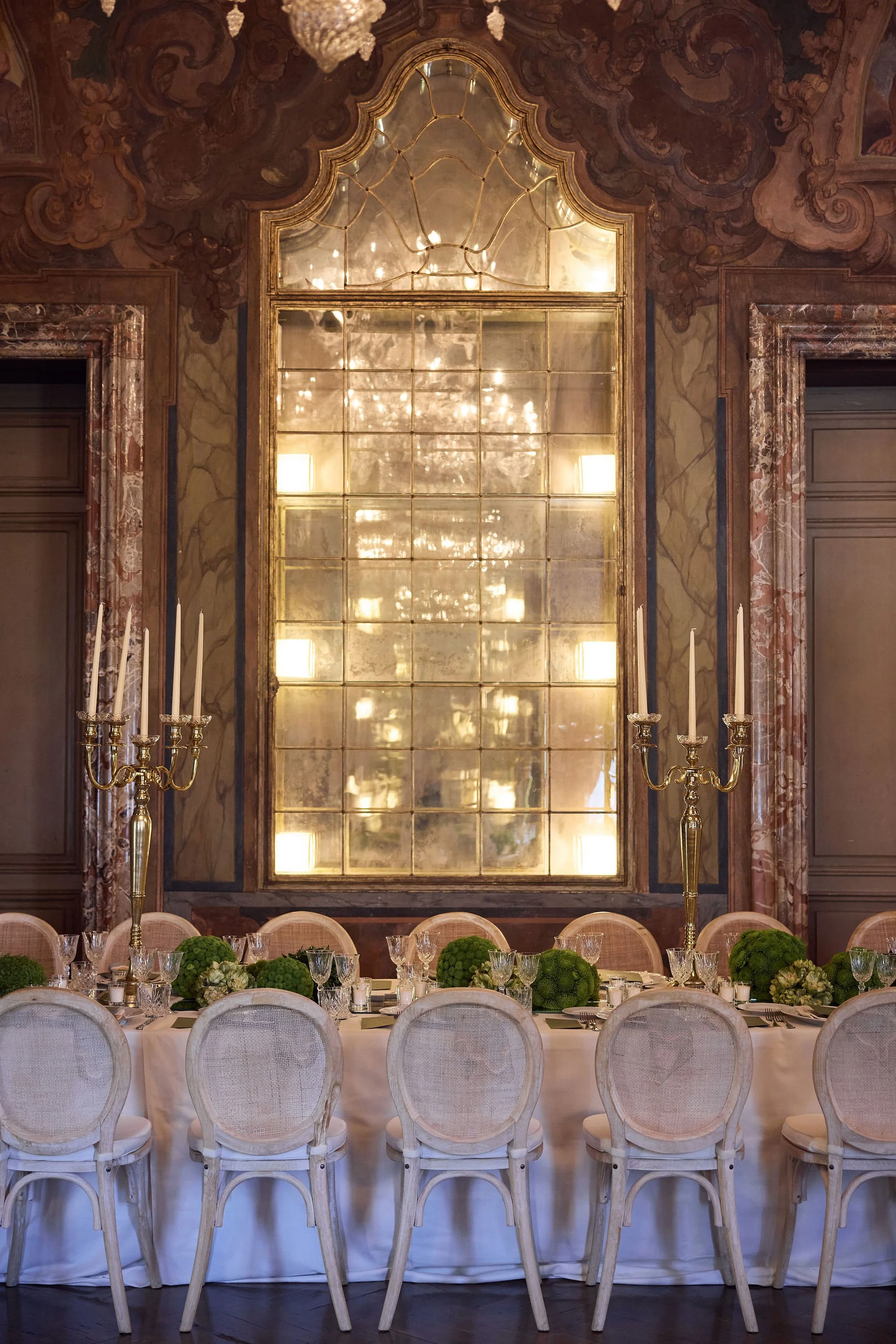 An ornate golden ballroom prepared for a wedding.