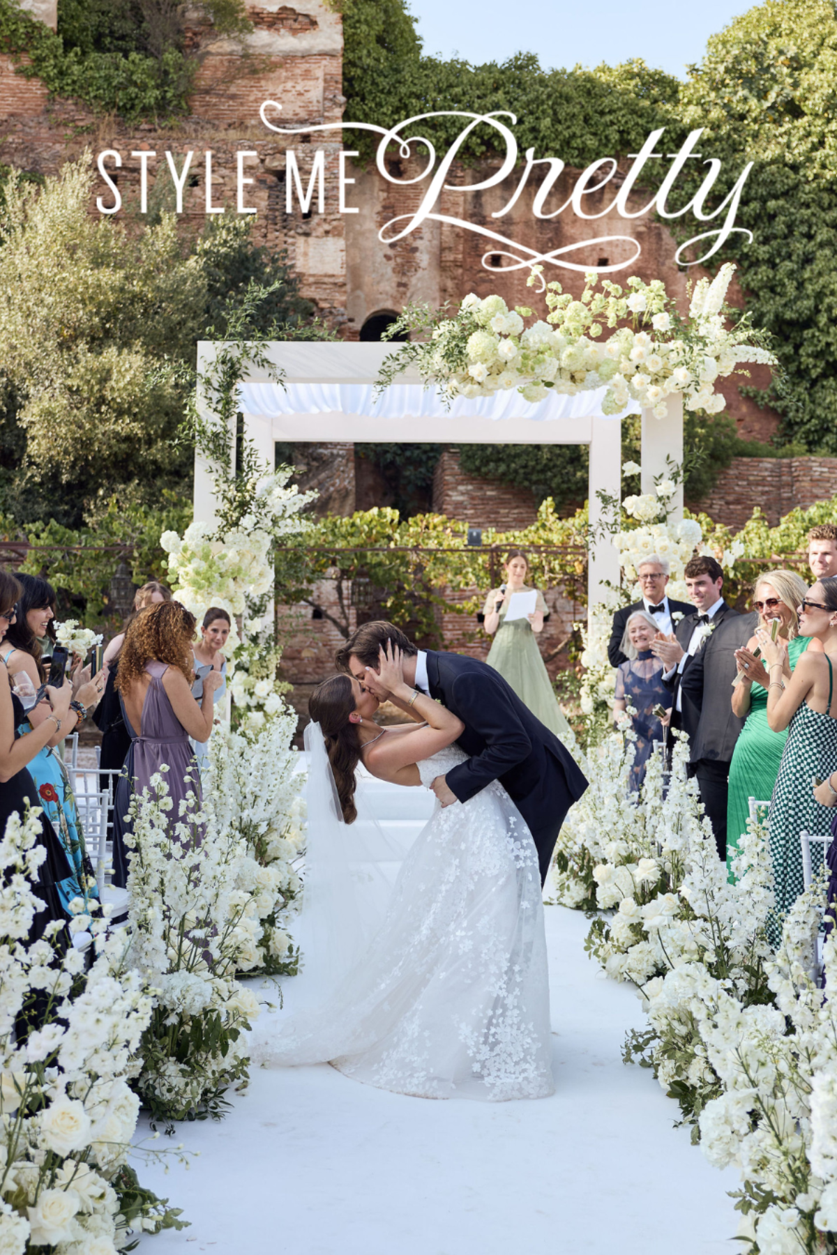 Style Me Pretty — couple kissing during their wedding ceremony