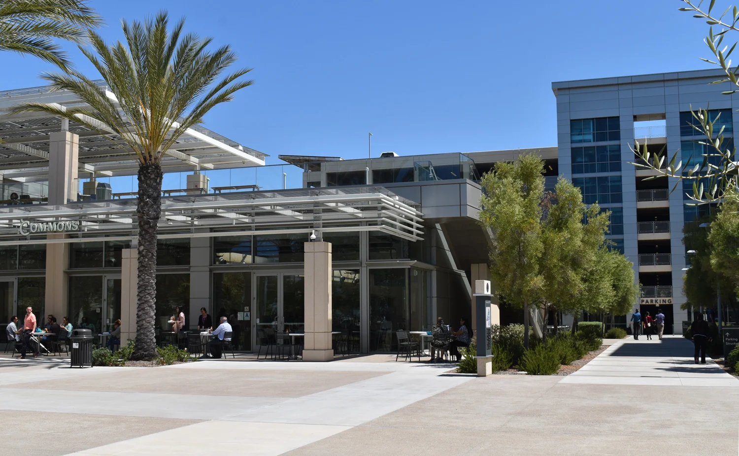The meetings will be held in the Campus Center Chambers, within the building seen to the left. The parking structure is seen on the right.