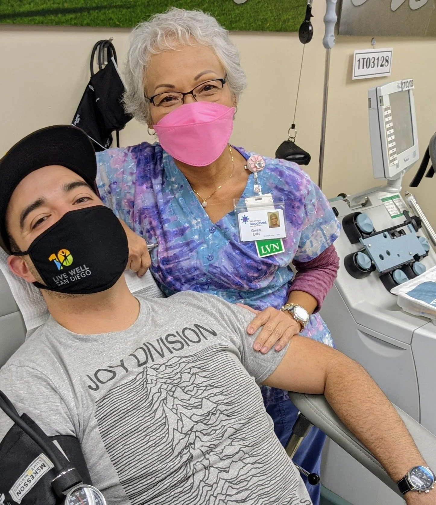 Man sits in chair with Blood Bank nurse