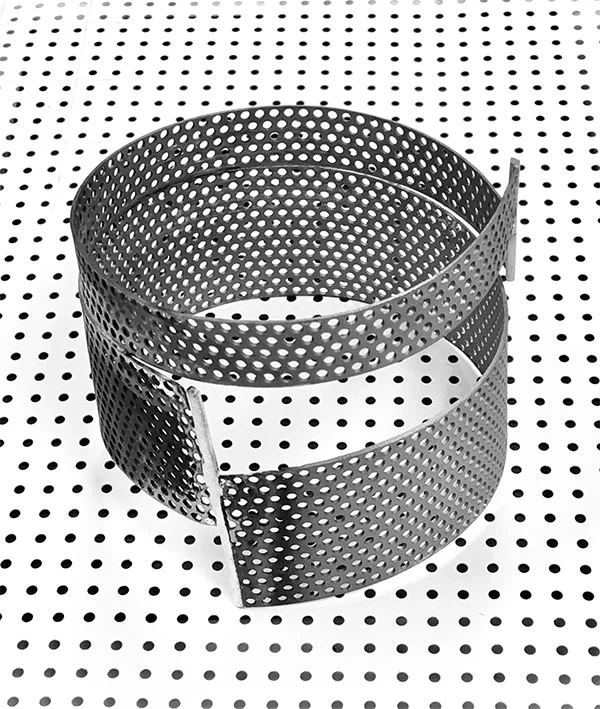 Round bangle with perforation. Sandblasted. Photographed on the paper used by architect to make paper mock-ups.