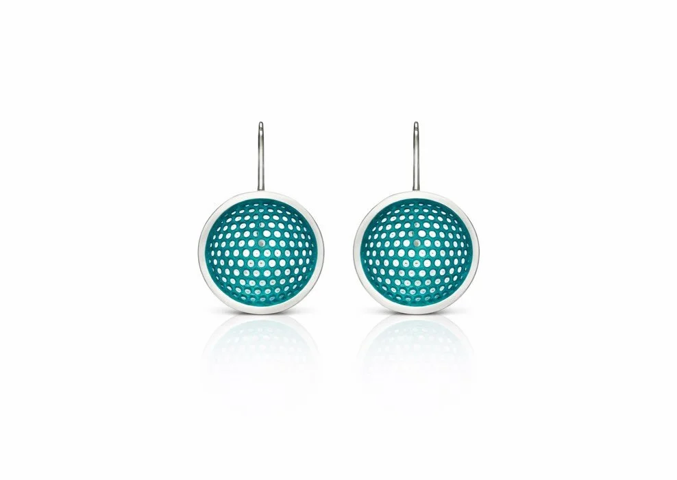 Turn heads and make a statement with these elegant teal perforated earrings, designed to enhance any outfit with their unique charm and sophistication.

Crafted with high-quality sterling silver for durability and elegance.

Features a unique perfora