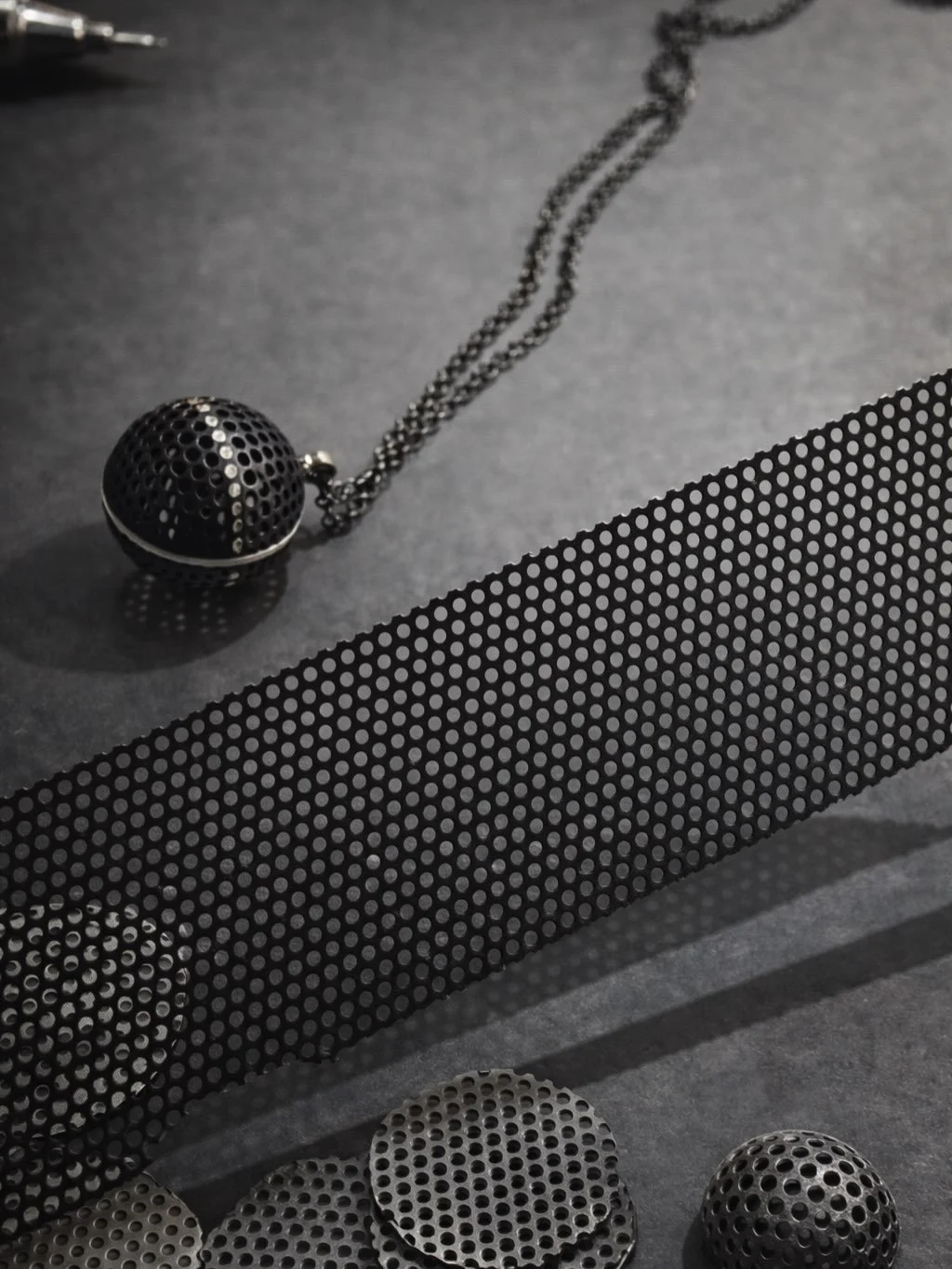 Celestial Perforation &ndash; Orb No.1
A hand-perforated sphere inspired by celestial forms.
Light moves through each opening, shifting across the surface.
Built slowly through cutting, forming, soldering, inlaying, blasting, powder coating, then fil