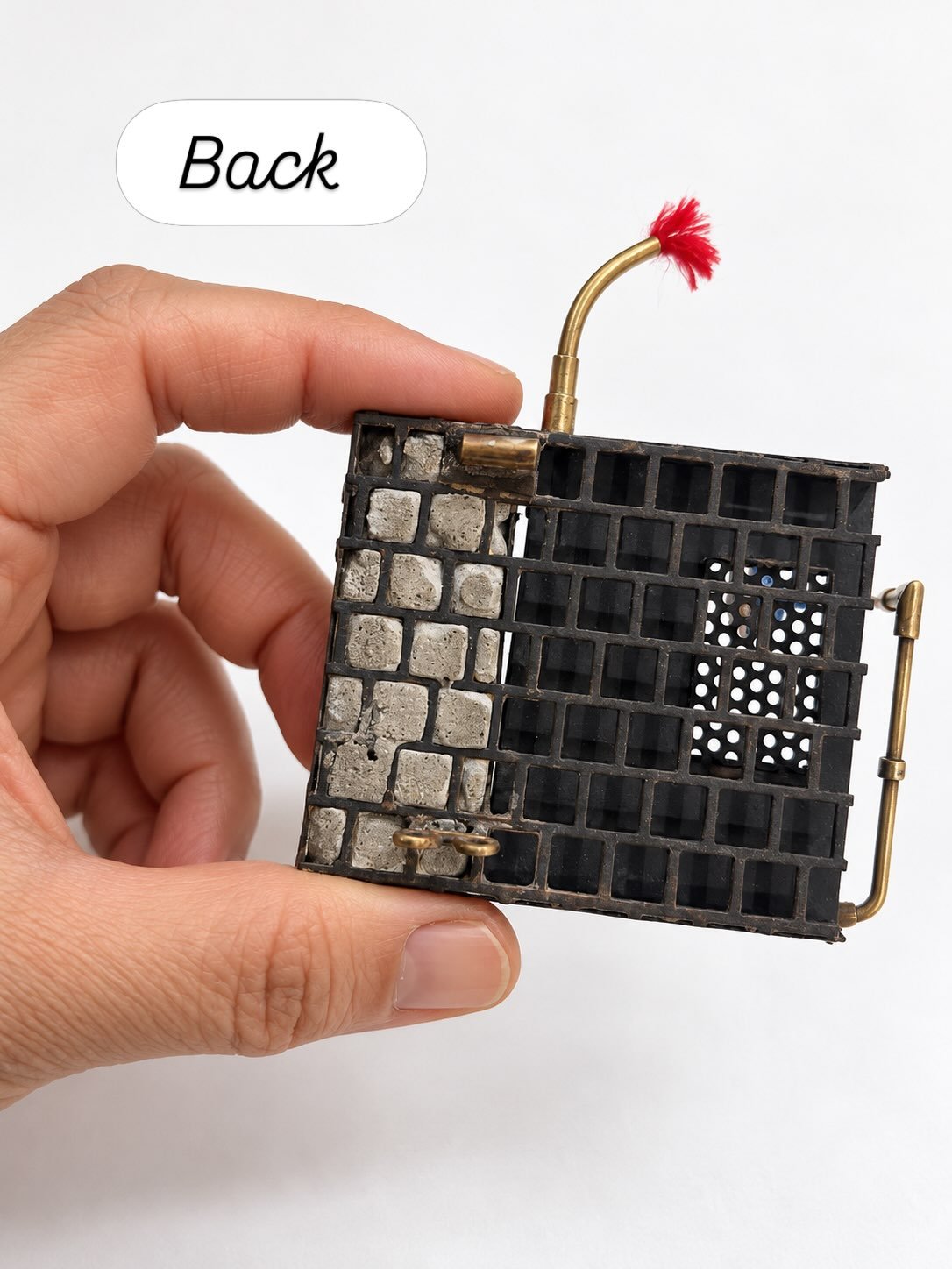 Sometimes I like the back of a brooch as much as I like the front.

This is the back of &ldquo;The Graffiti Wall&rdquo;, from my new collection The City and Its Uncertain Walls-Brooch

I used different perforation patterns throughout this series, inc