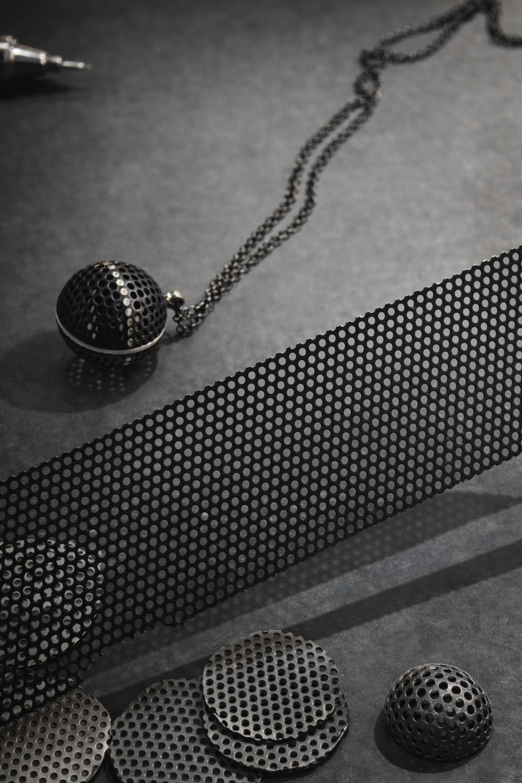 Perforated metal and handmade pendant.png