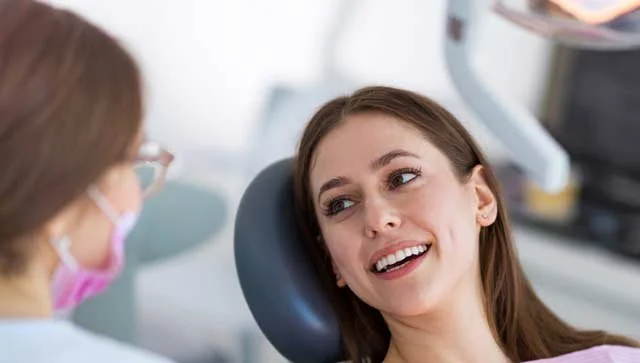 Image shows a Dental Hygienist talking to a patient at London Dental Hygiene