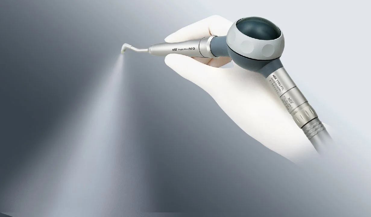 dental hygiene airflow machine being used by Hygienist