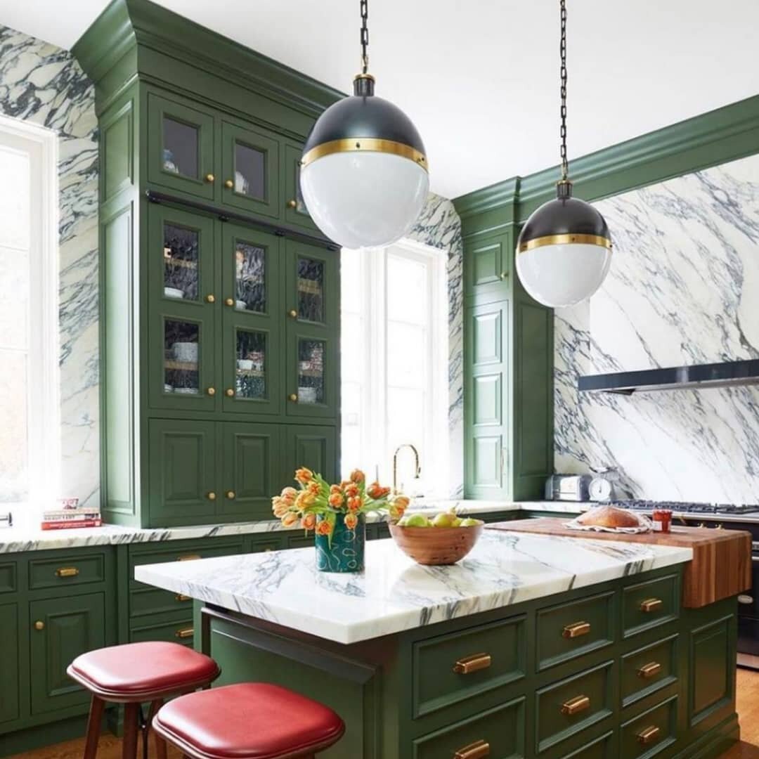 What do you think of this green kitchen? We think it goes perfectly with the marble walls and countertops!