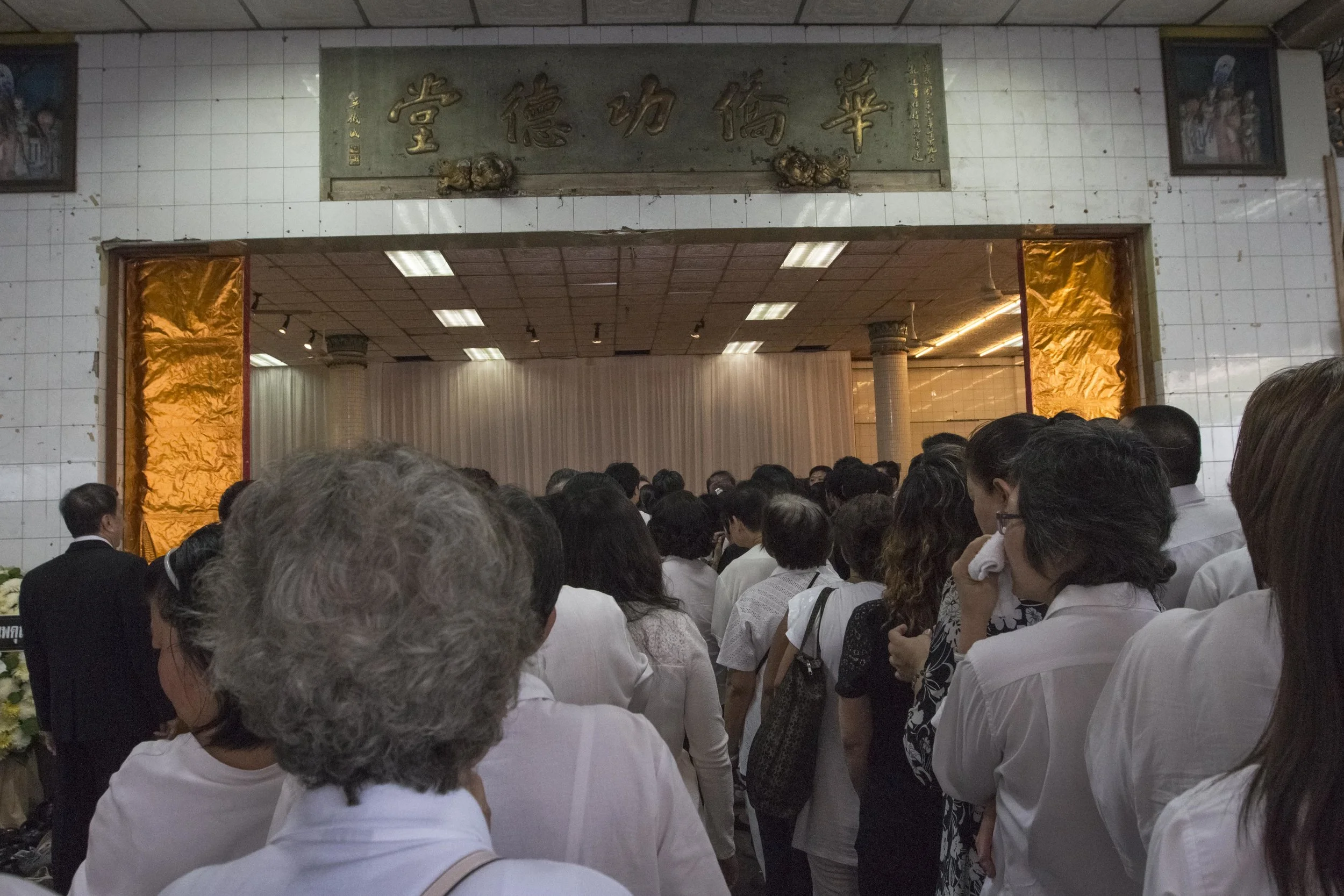 Mourners line up waiting to pay their respects to the body of the late abbot
