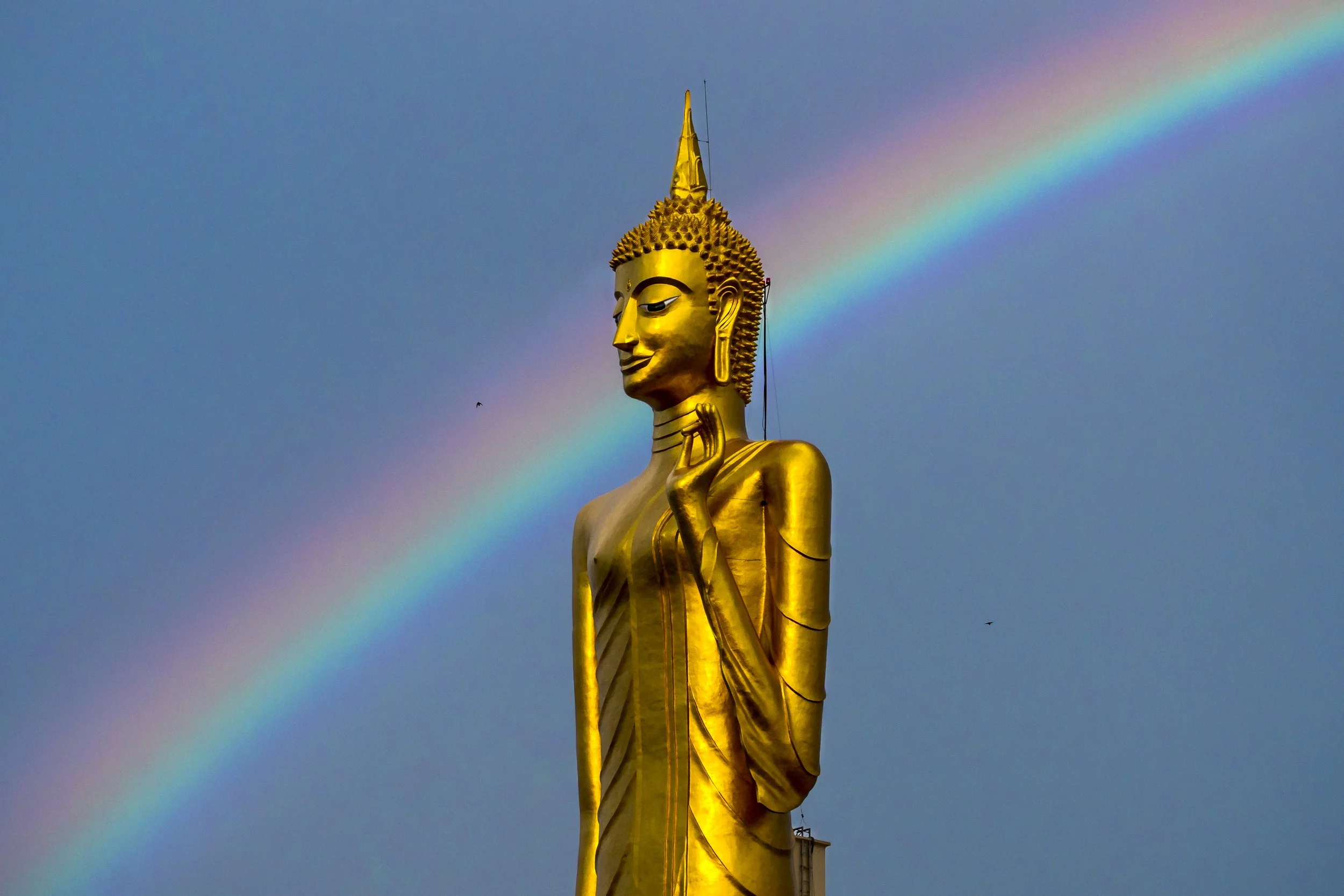  May 31, 2026: Thailand’s tallest standing Buddha, the Luang Pho Yai statue towering over 68 meters high including it’s base structure, is seen at dawn with a rainbow in the background in Roi Et, Thailand. 