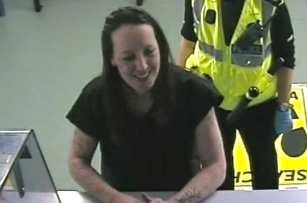 Joanna being booked into the police station.