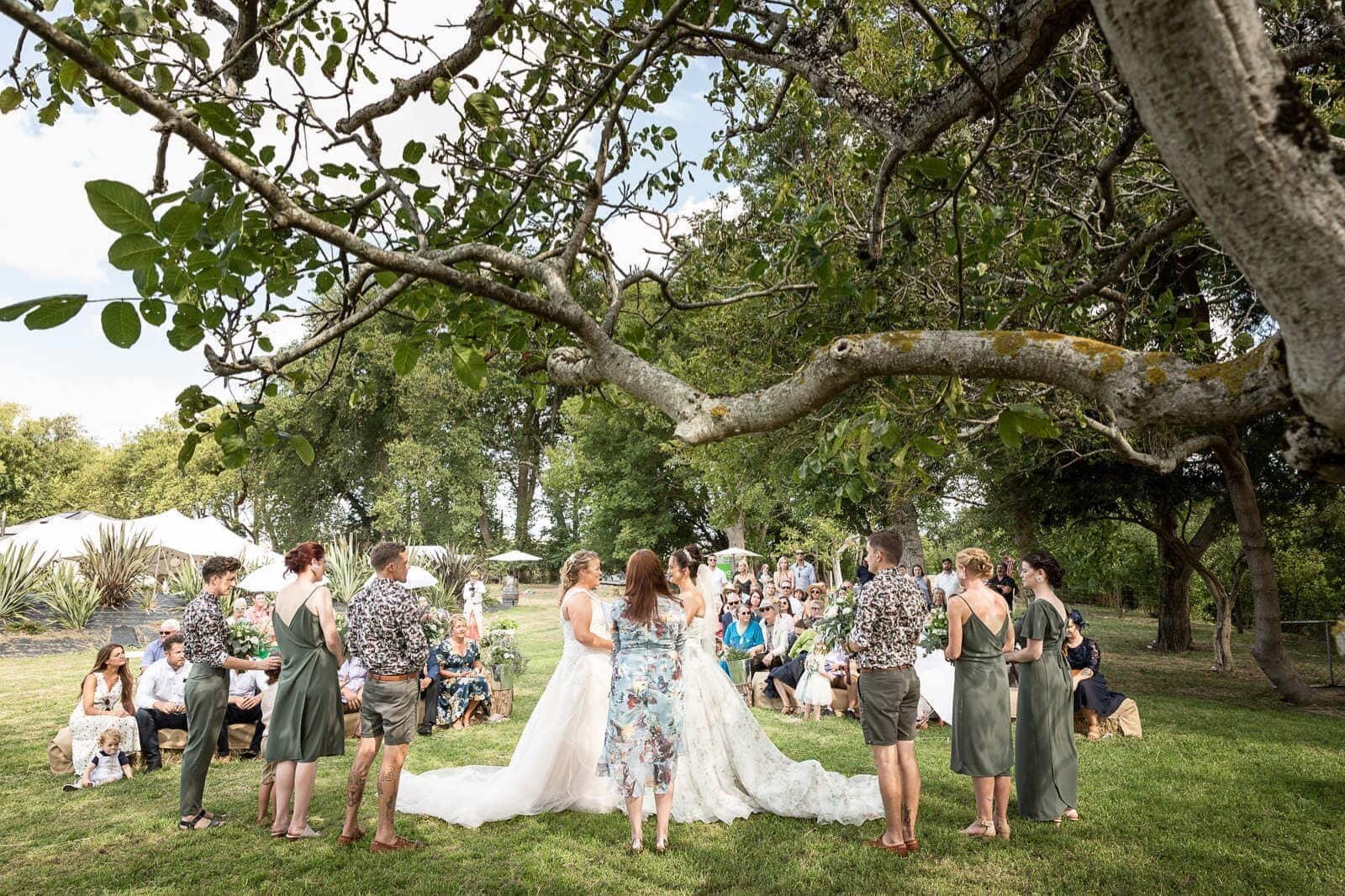  Chloe and Libby take their vows amongst their nearest and dearest in a stunning backyard with that amazing tree as the perfect backdrop!  Images by Mel Waite Photography  