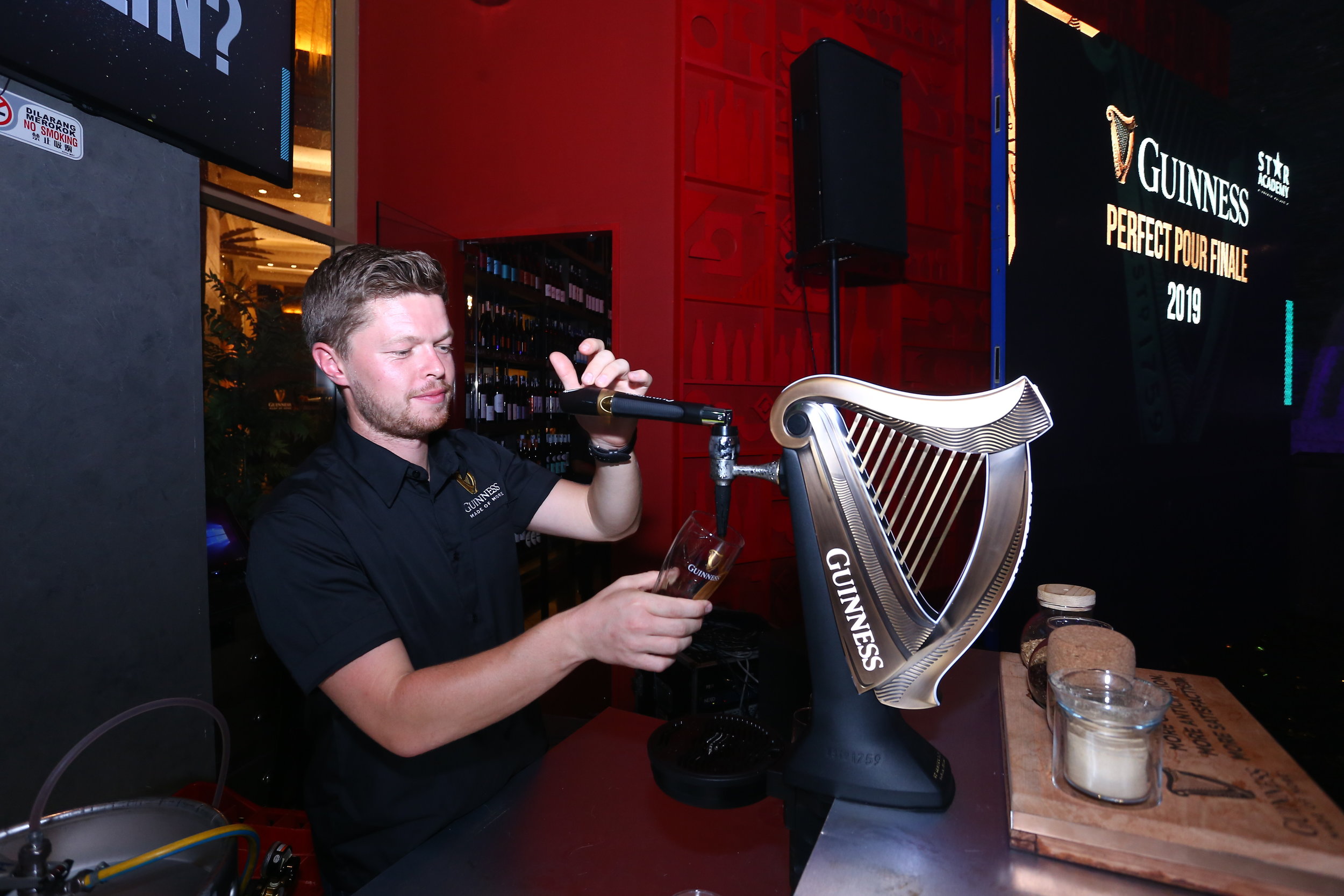  Cian Hulm, Guinness Brand Ambassador showcases the two-part pour needed for the perfect pint of Guinness 