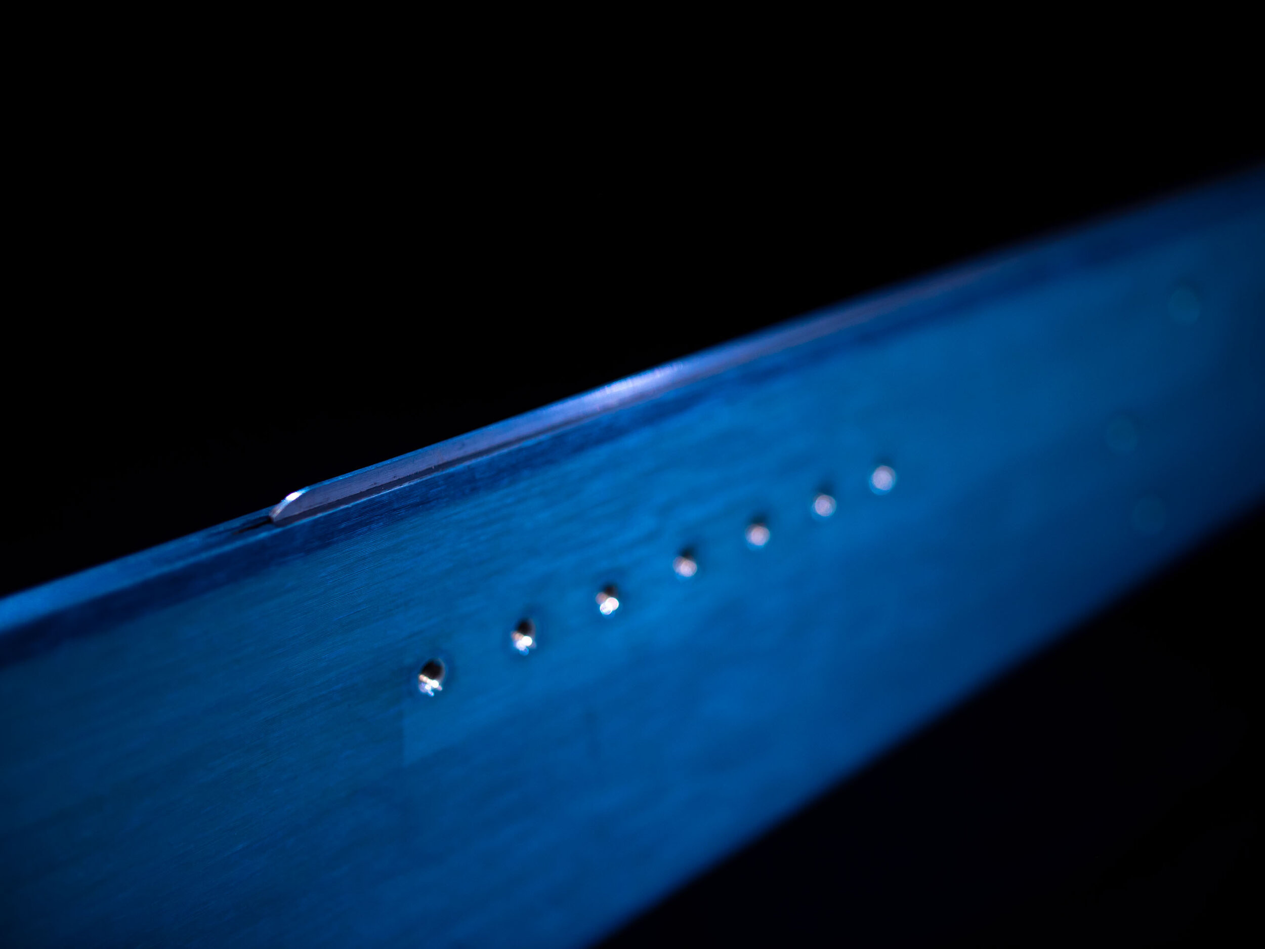 The tongue is made out of thick stainless steel. This in combination of it only sticking out 3mm from the sidewall makes it very durable and compatible with crampons.
