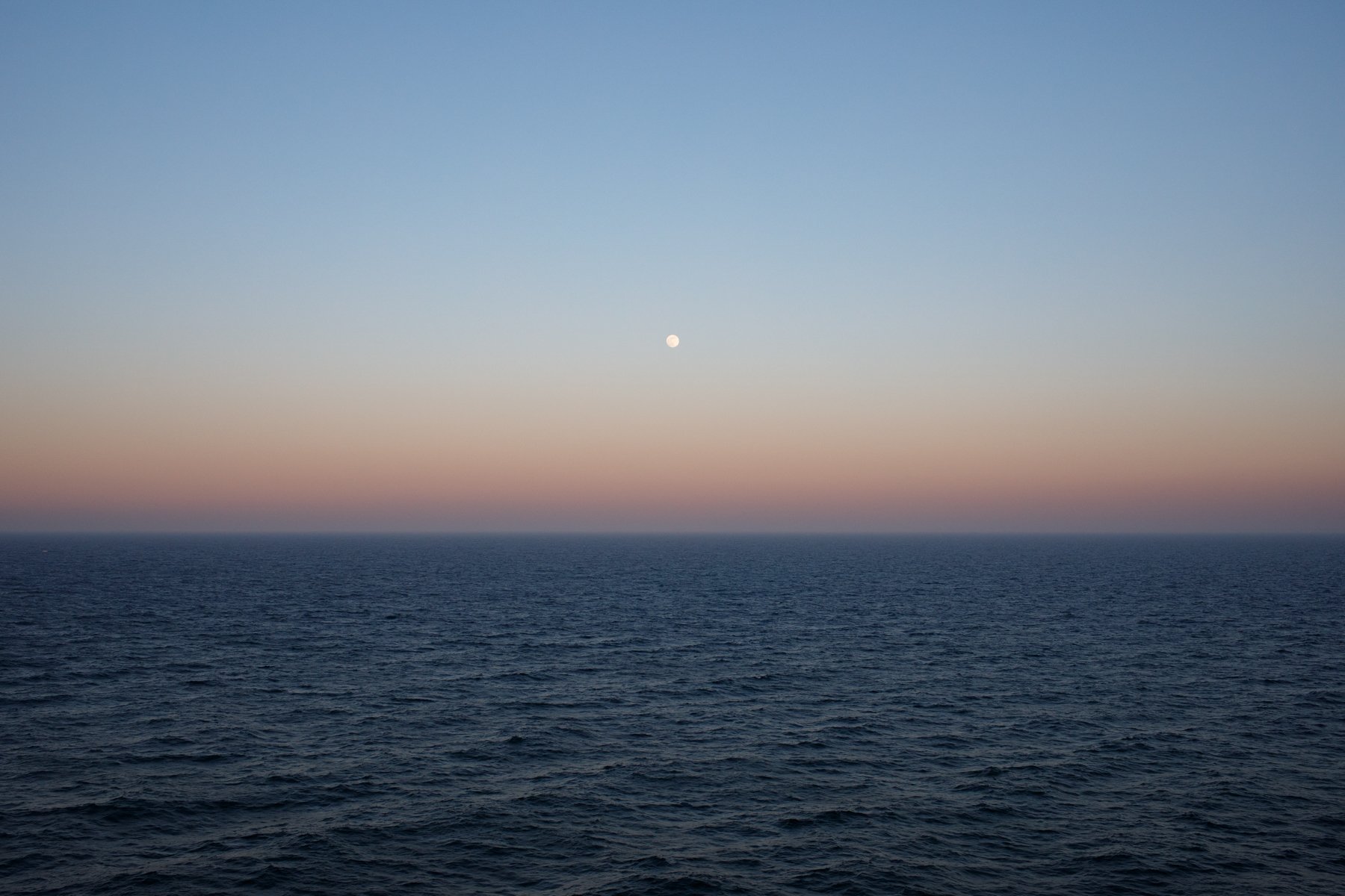  A full moon rising over the Baltic Sea at dusk. 