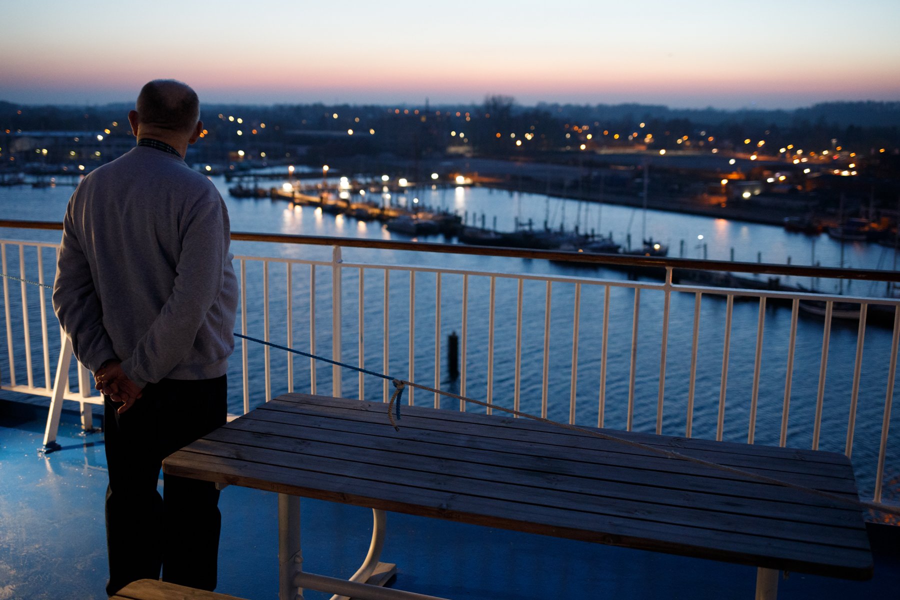  A man watches the shore as  Finnlady  enters Travemünde. 