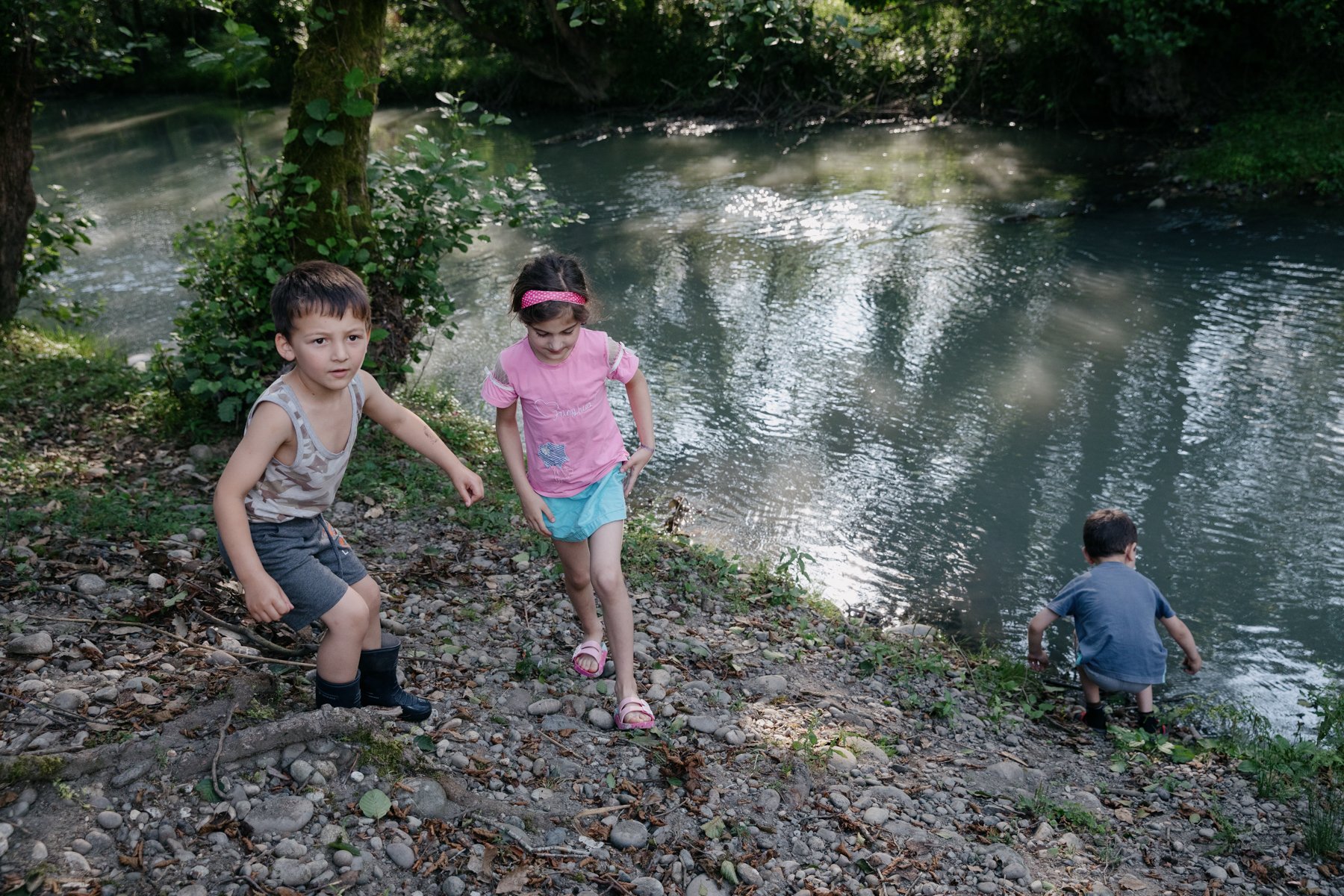  5-year-old Giorgi Ekhvaia, left, plays with friends beside an offshoot of the Enguri River in Khurcha. The opposite bank just a few feet away is occupied Abkhazia. A large Russian base is located in Nabakevi, the village on the other side of the riv