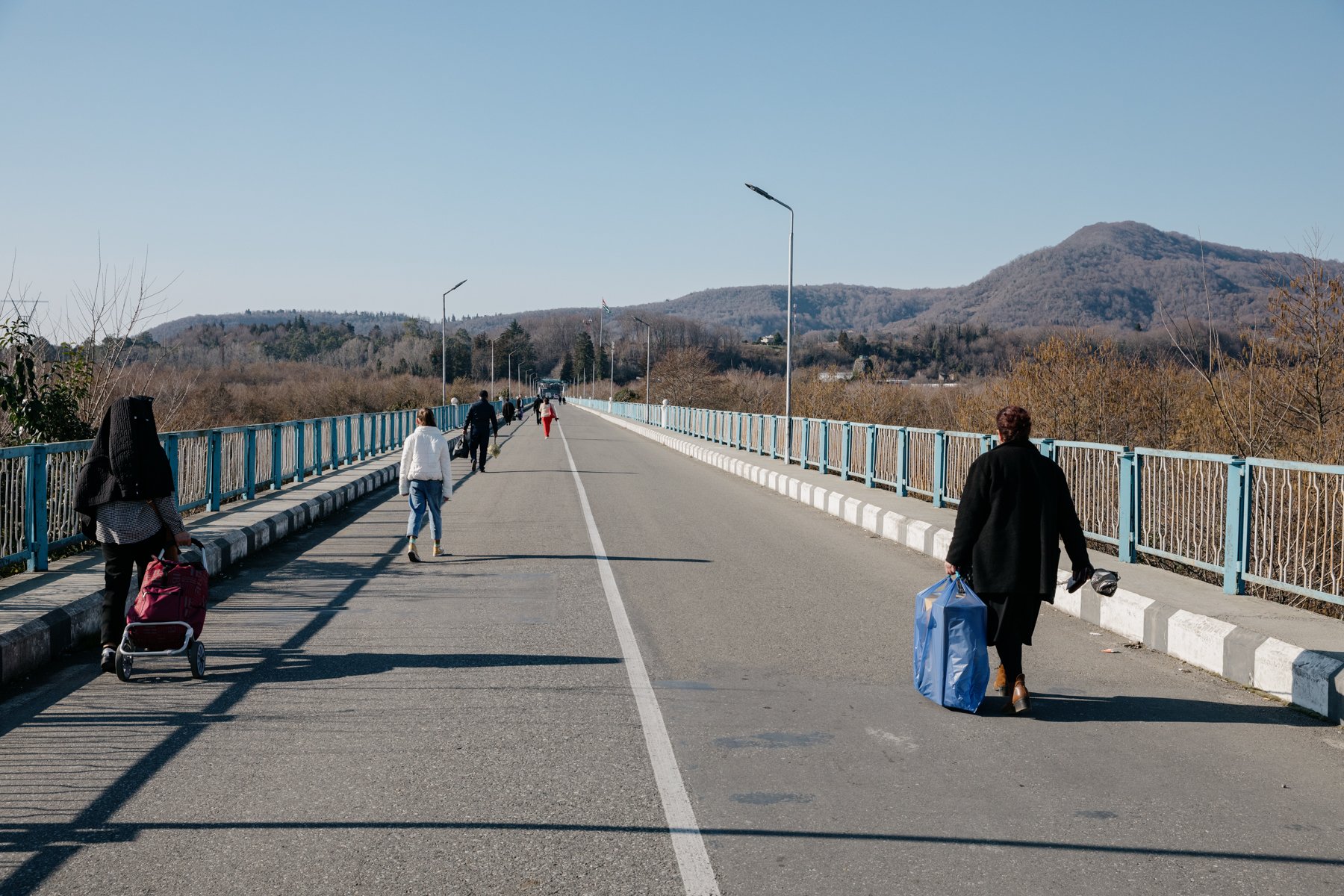  Residents of Abkhazia walk towards the occupied territory across the Enguri Bridge. 