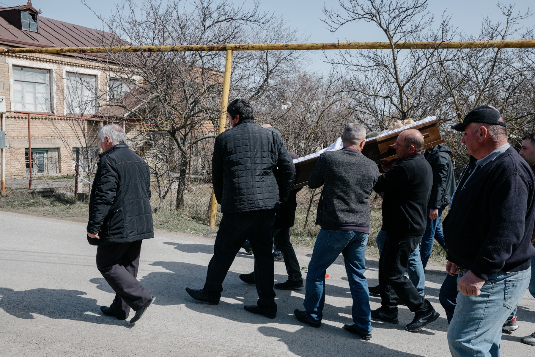  A funeral procession winds its way towards the cemetery in Nikozi. 