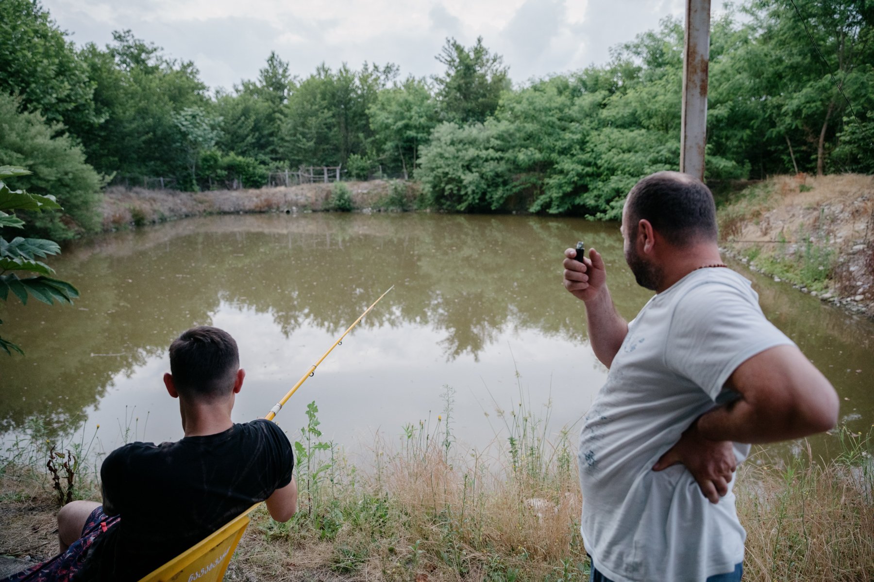  Men fish in a pond that sits next to the occupation line in Khurcha. Nearby is a small bridge that provided a crossing point with Abkhazia until it was closed by Russian forces in March 2017. 