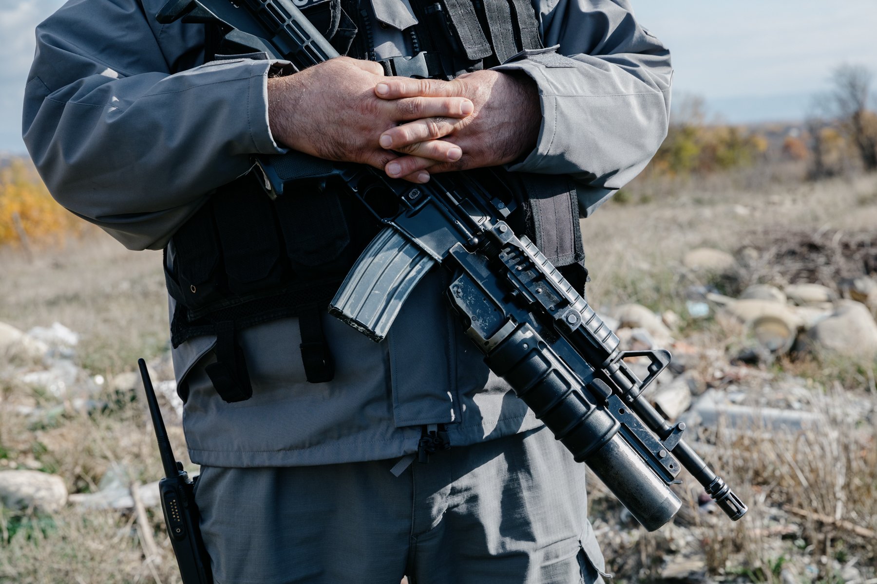  A Georgian police officer on a ridge in Upper Nikozi overlooking Tskhinvali, the de-facto capital of South Ossetia. 