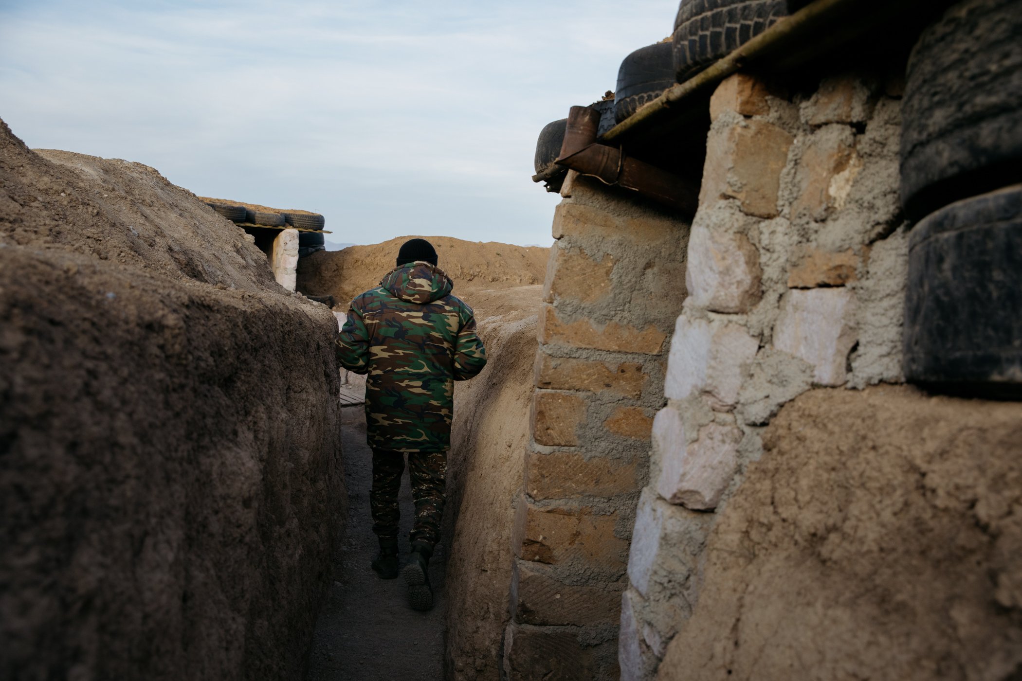  The commander of an Armenian military position on the border with Azerbaijan walks through the trenches. 