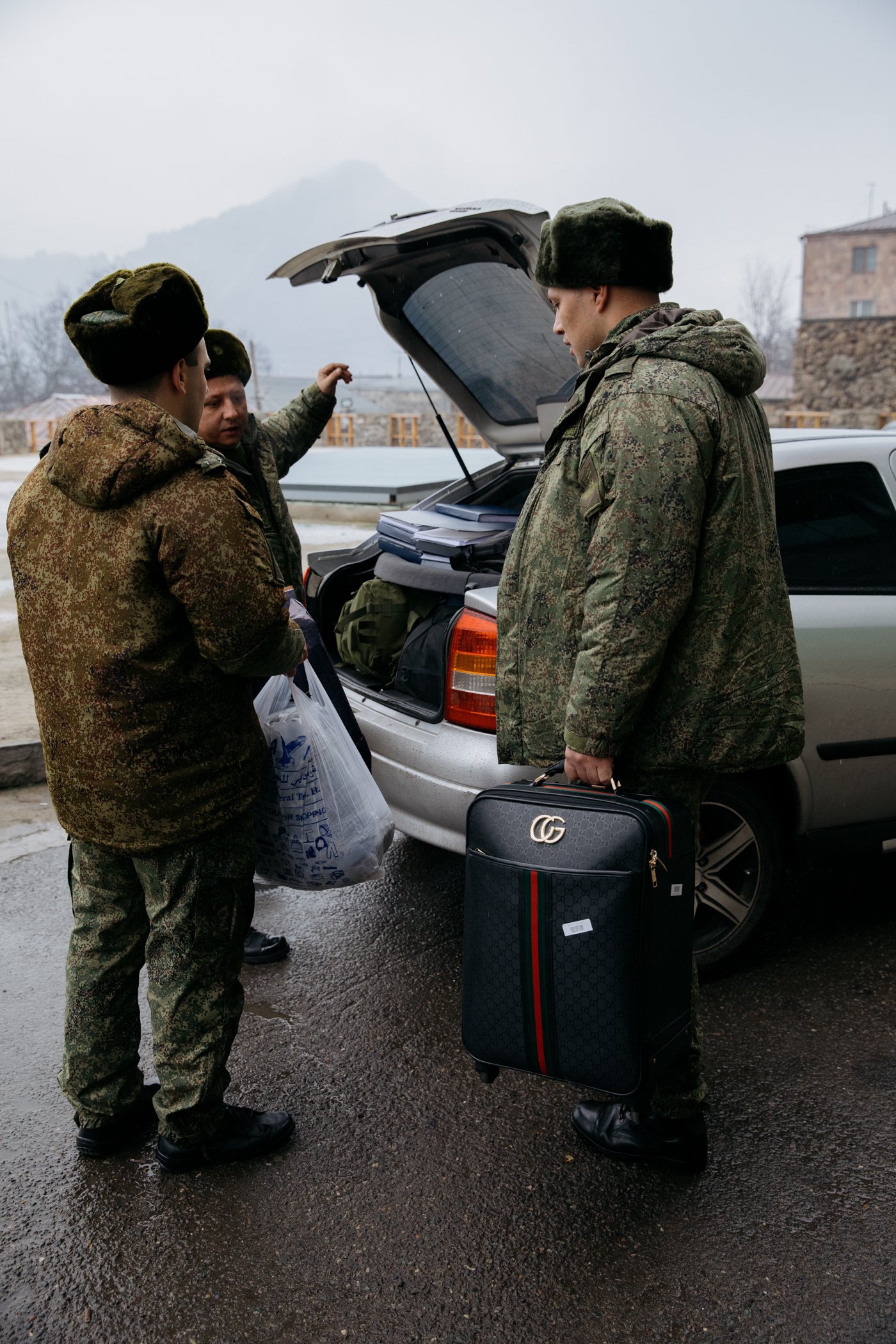 Russian soldiers outside the Hotel Goris, one carrying the luggage of a female acquaintance who left with them. 