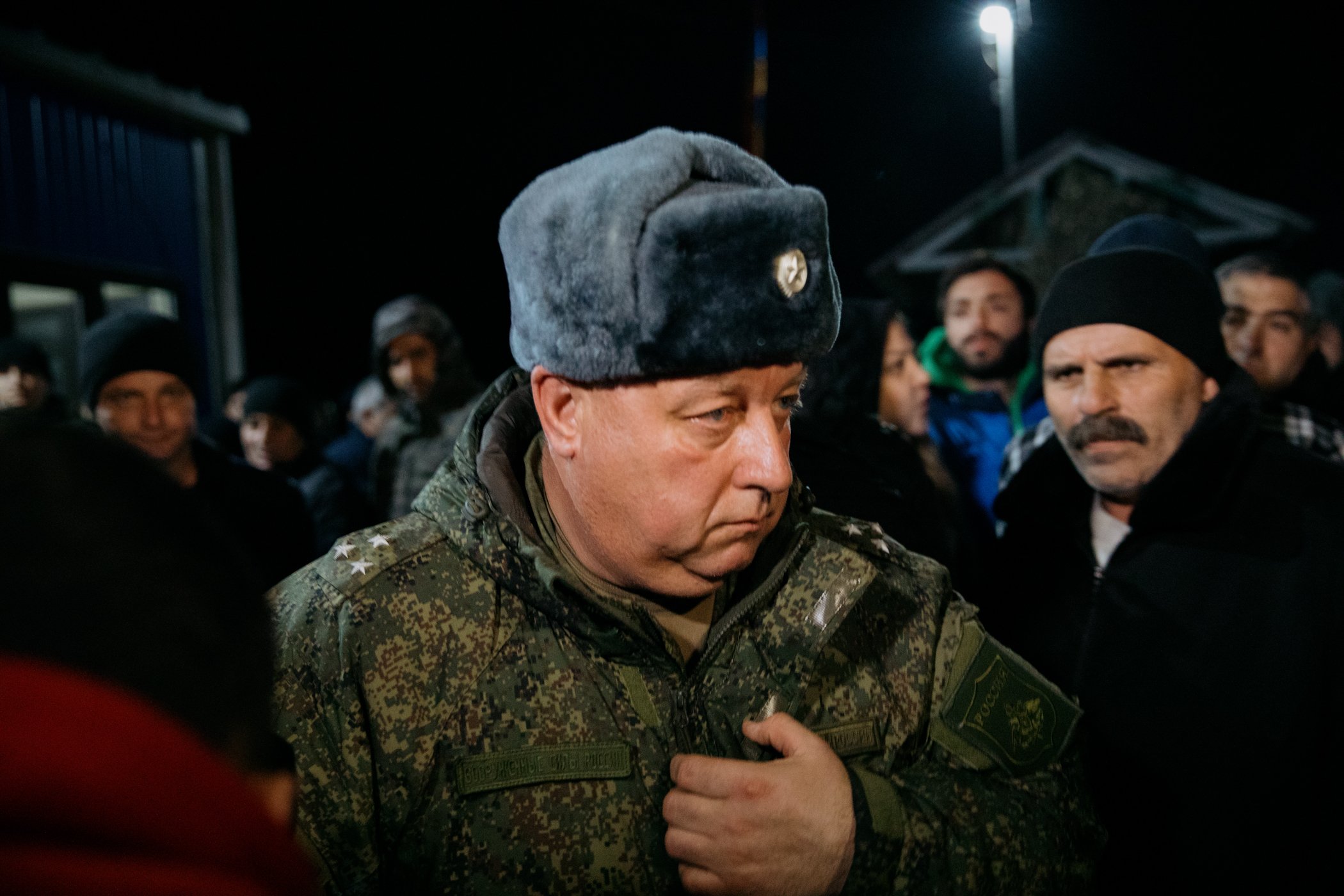  Igor Sazonov, a senior officer in the Russian peacekeeping force, leaves the Tegh checkpoint after negotiations with protestors demanding the reopening of the Lachin Corridor. Yura, right, is a resident of Stepanakert who travelled to Armenia with h