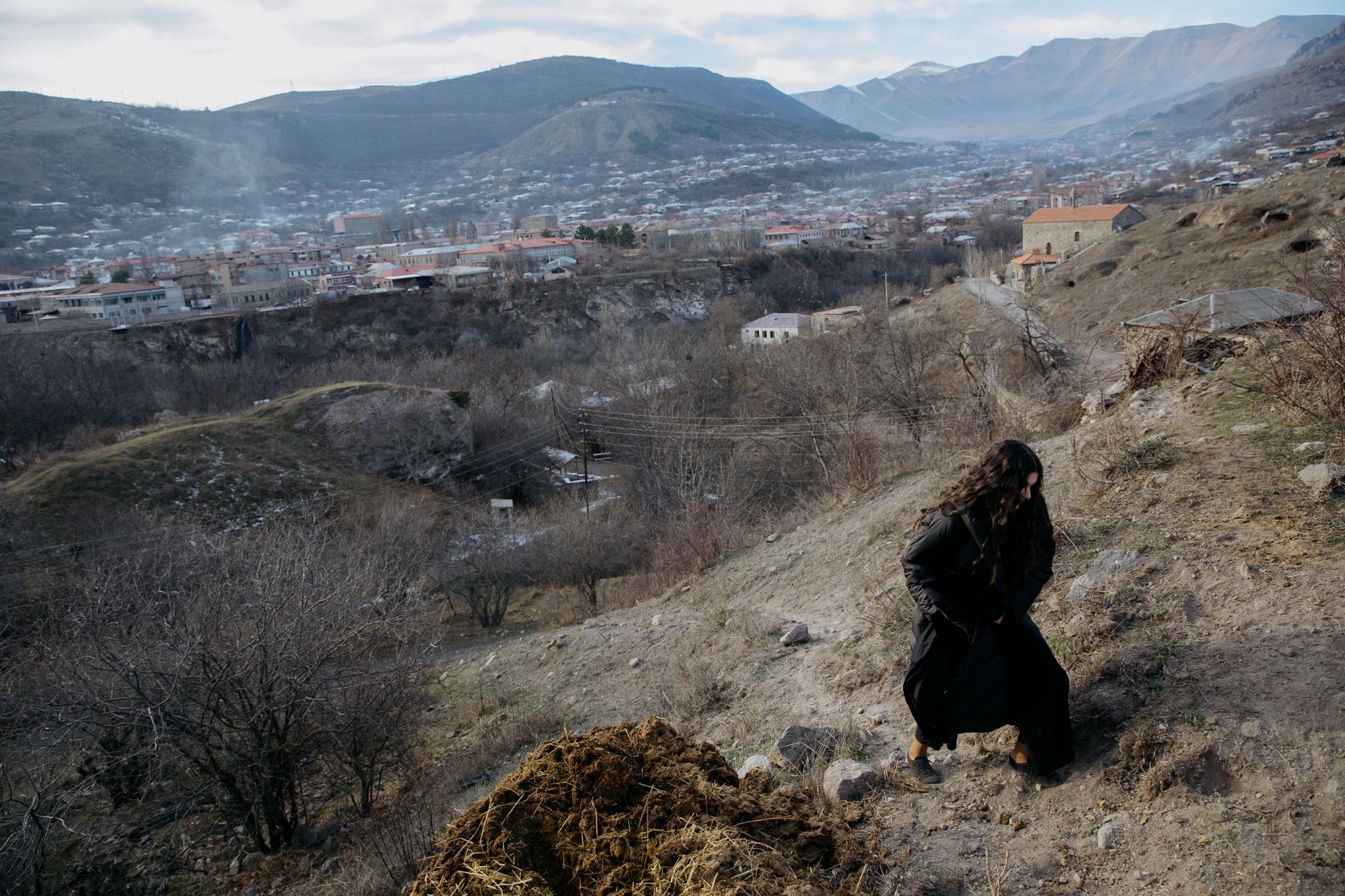  Anita Kagramanyan, a member of the Asparez dance group, walks up a hill on the edge of Goris to film a video. 
