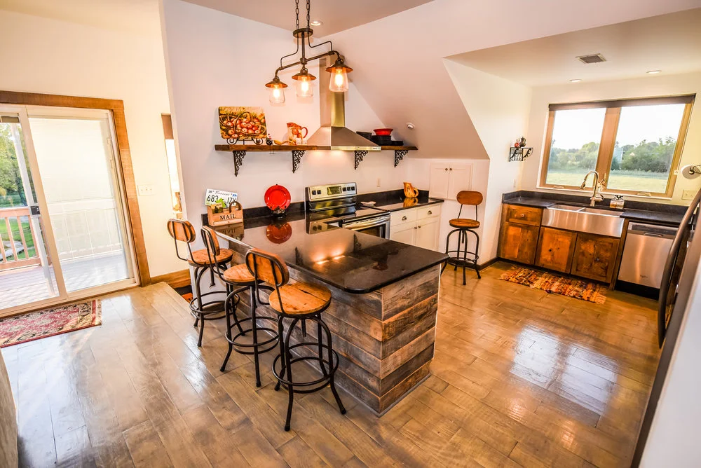 Charming rustic kitchen with window overlooking the farm and sunset fields.