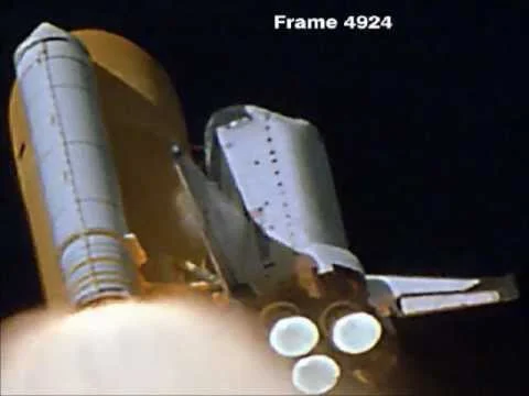 Frame of NASA launch footage showing the moment the foam struck the shuttle’s left wing (Creative Commons)