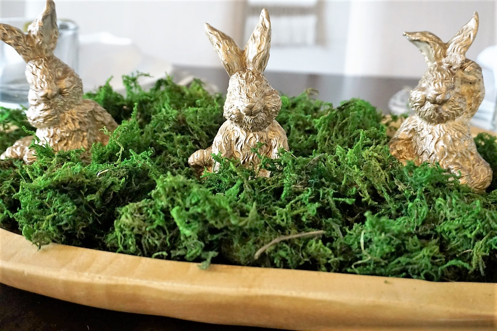 Thrift store Easter decor was spruced up with gold spray paint, green moss, and a dough bowl.