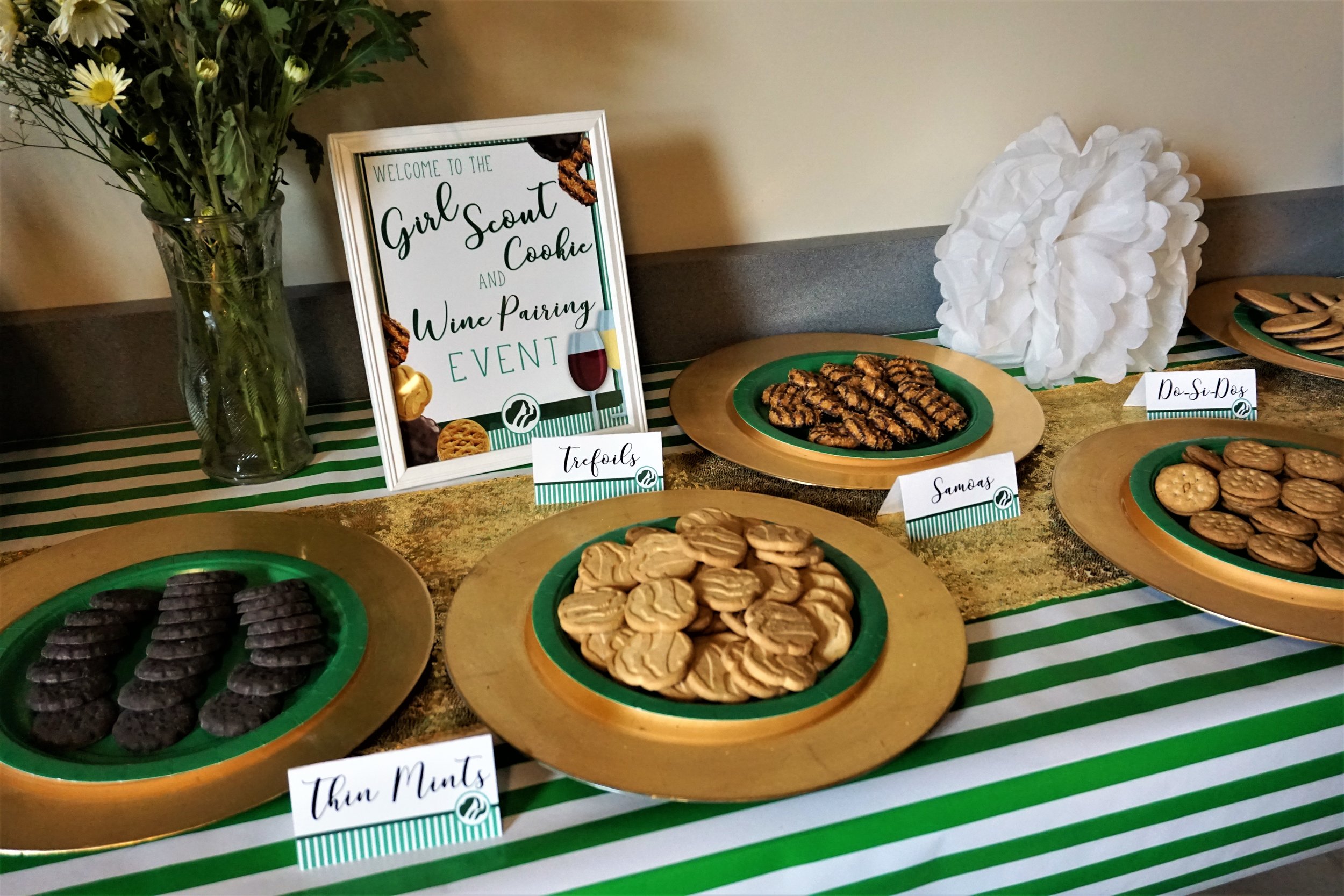 Use gold chargers and green plates to serve Girl Scout cookies at a Girl Scout cookie and wine pairing party.