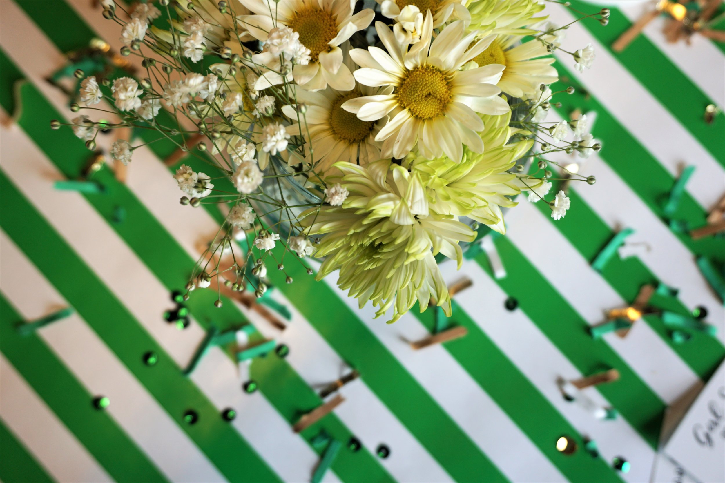 Daisy floral and green and gold confetti for a Girl Scout party.