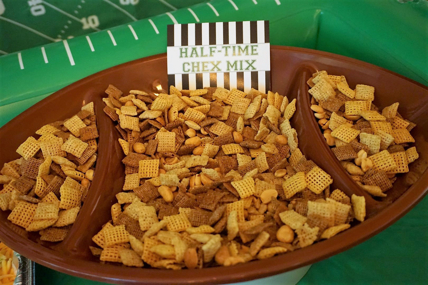  Chex mix in a football shaped bowl for football snacks. 
