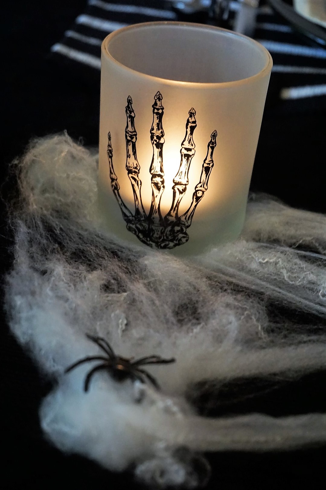  This pretty candle was a Dollar Tree find! Spooky chic doesn’t have to be expensive. Click here to see how to re-create this Halloween table! | Legally Crafty #halloweentable #halloweendiy #diyplacecards #halloweendecor #halloweendinnerparty 
