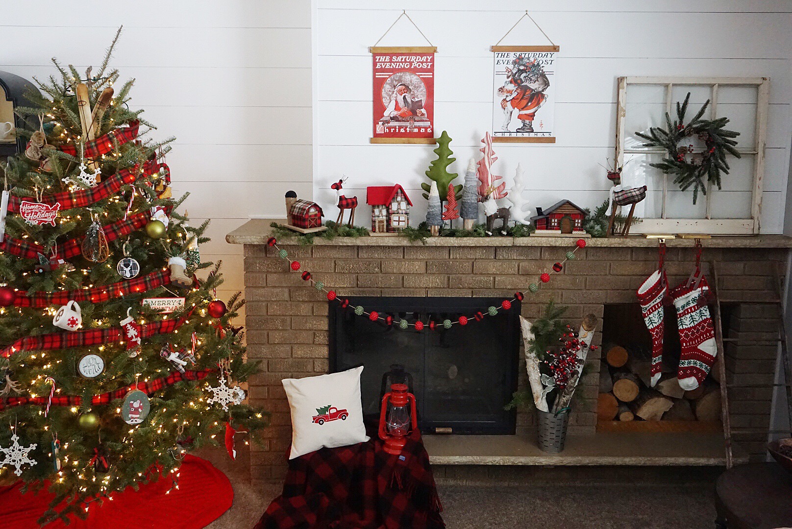 A vintage themed Christmas mantel with plaid houses, plaid pom garland, and vintage posters.