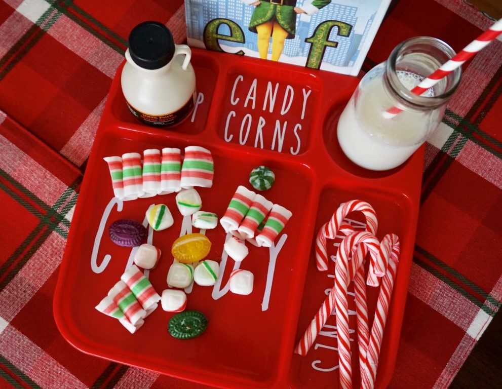  Old fashioned candy, candy canes, and syrup can make a fun snack or centerpiece for an Elf Movie Night! It looks perfect on a DIY tray! 