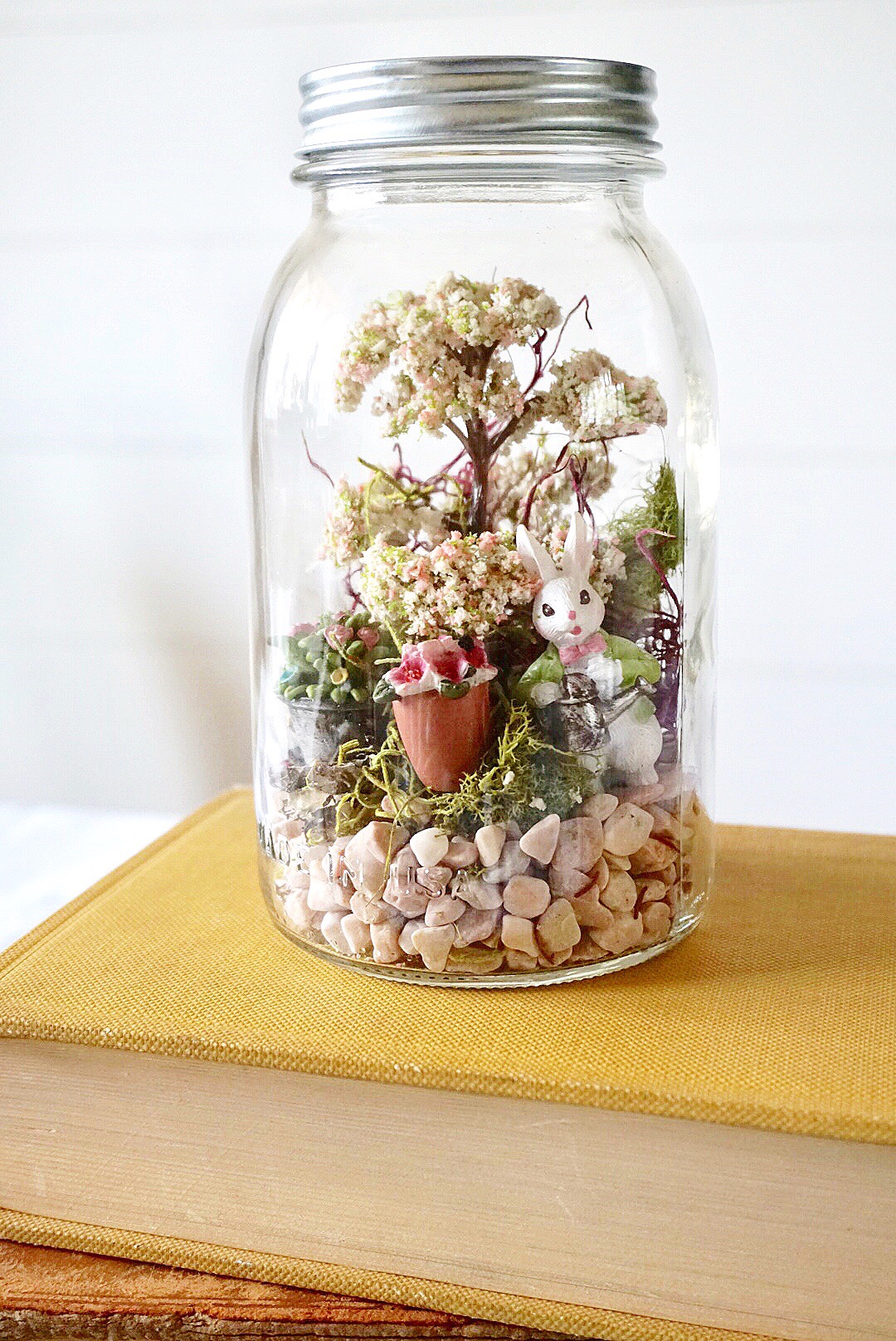  DIY Mason Jar Easter Fairy Garden Terrarium made with bunny figurines and moss. 