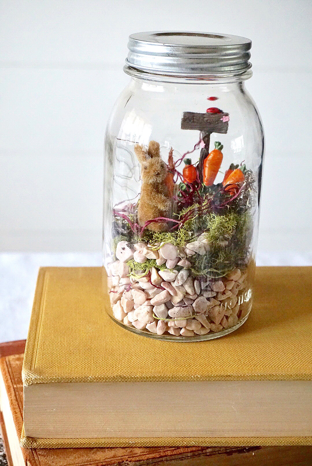 DIY Mason Jar Easter Fairy Garden Terrarium made with bunny figurines and moss. 