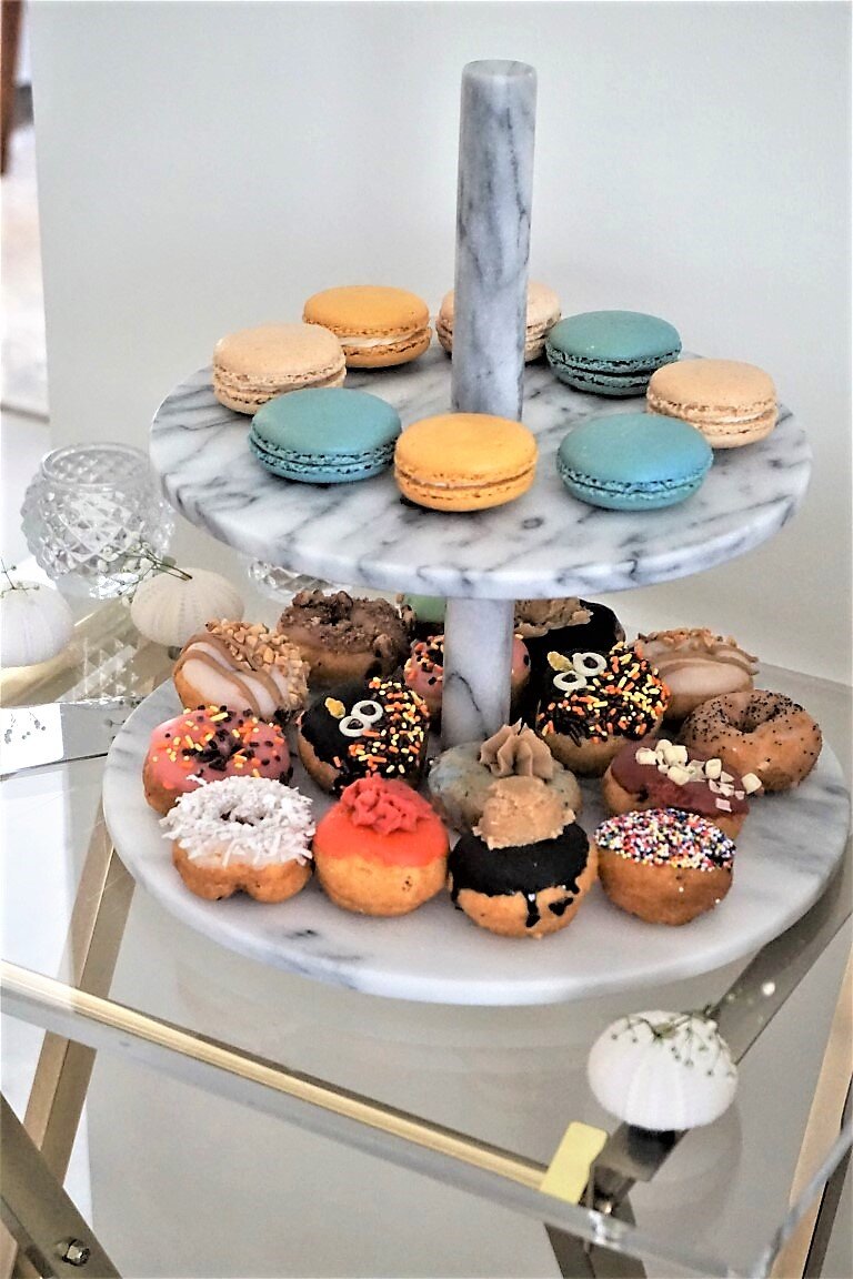  Mini donuts and macaroons on a dessert stand 