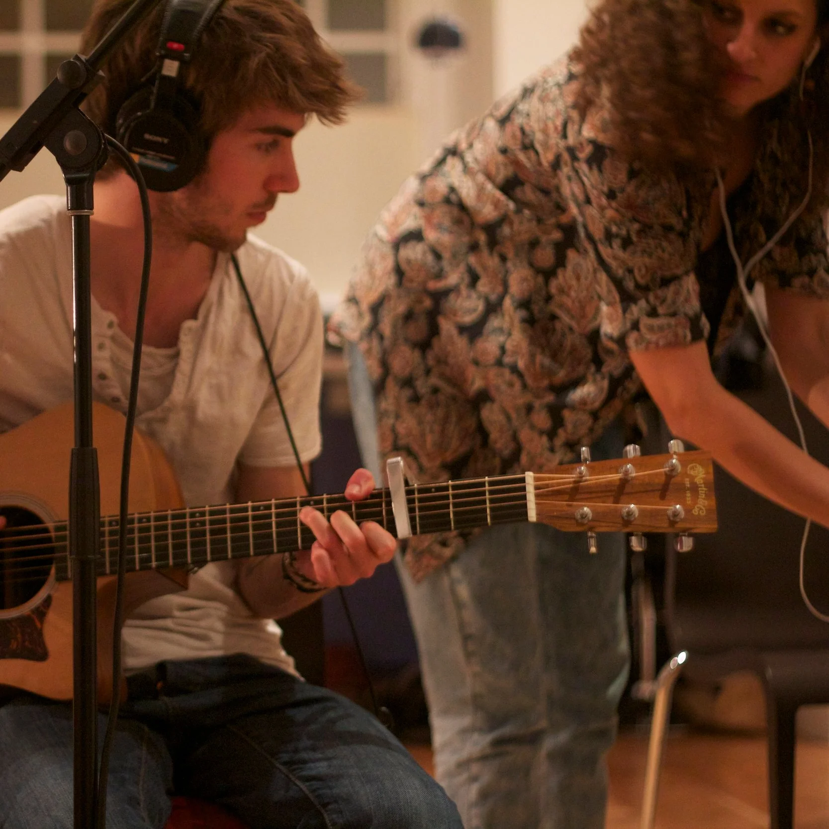 Raphael Luther , AKA Lyosun who played acoustic guitar in China Doll on the Feral City EP recording guitar at a house with beautiful acoustics in Southwest London.