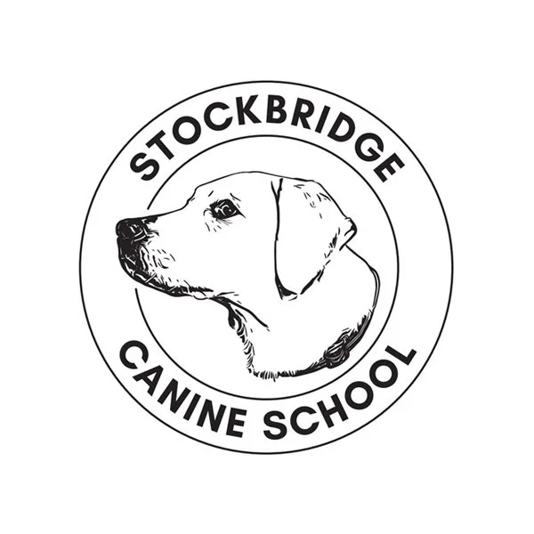 Black line drawing of a Labrador dog's head in a circle with the words Stockbridge Canine School in another circle outside in black capital letters.