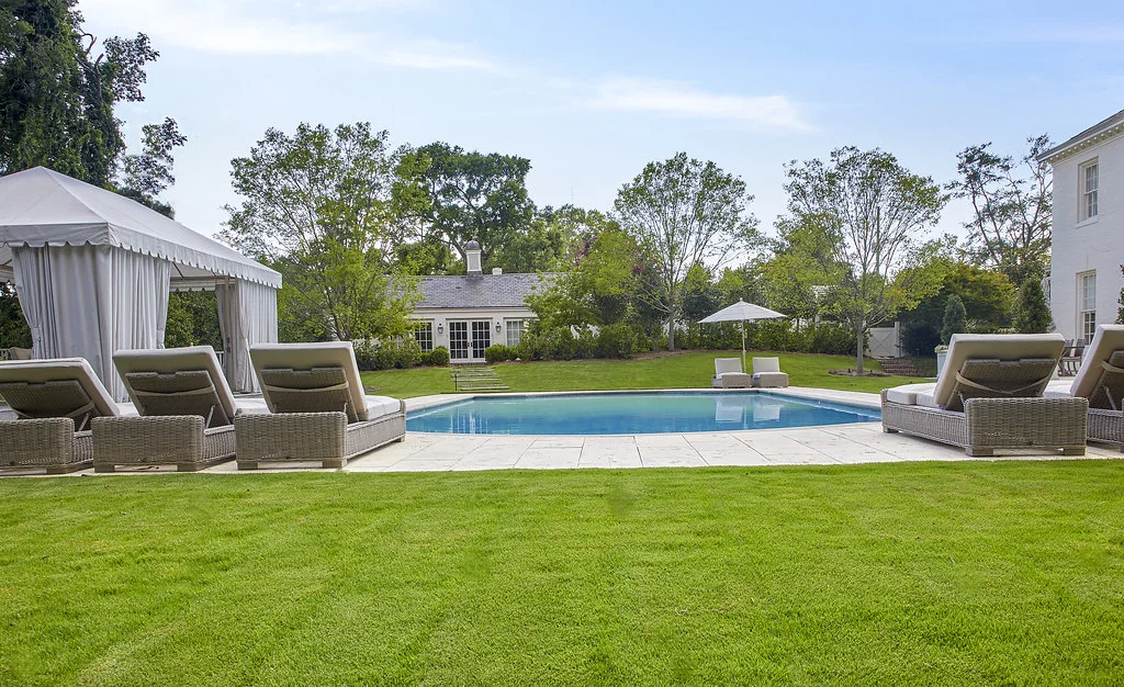 View of the pool from the green grass.