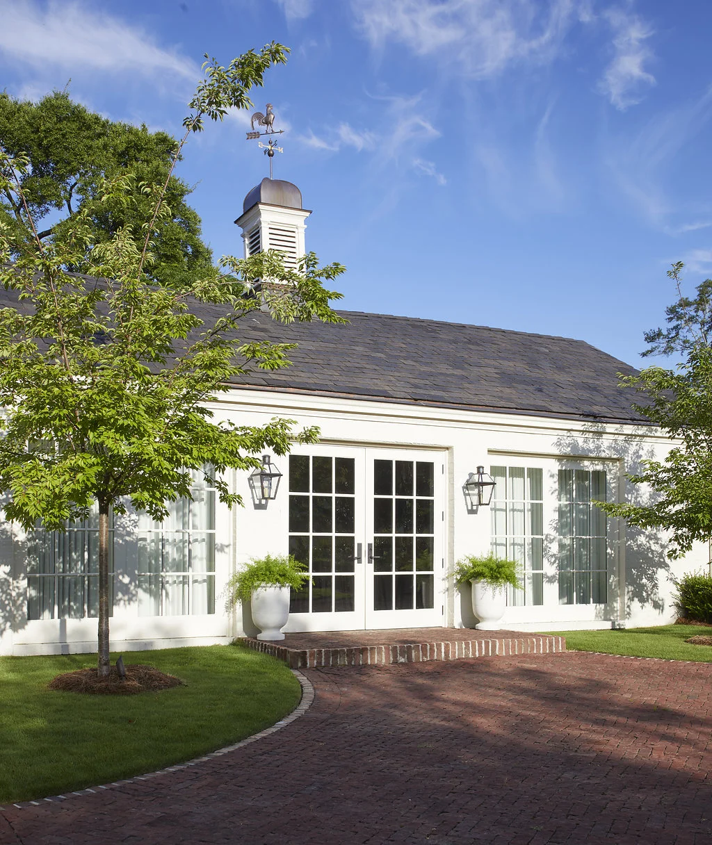 A view of the repurposed brick driveway leading to the pool house.