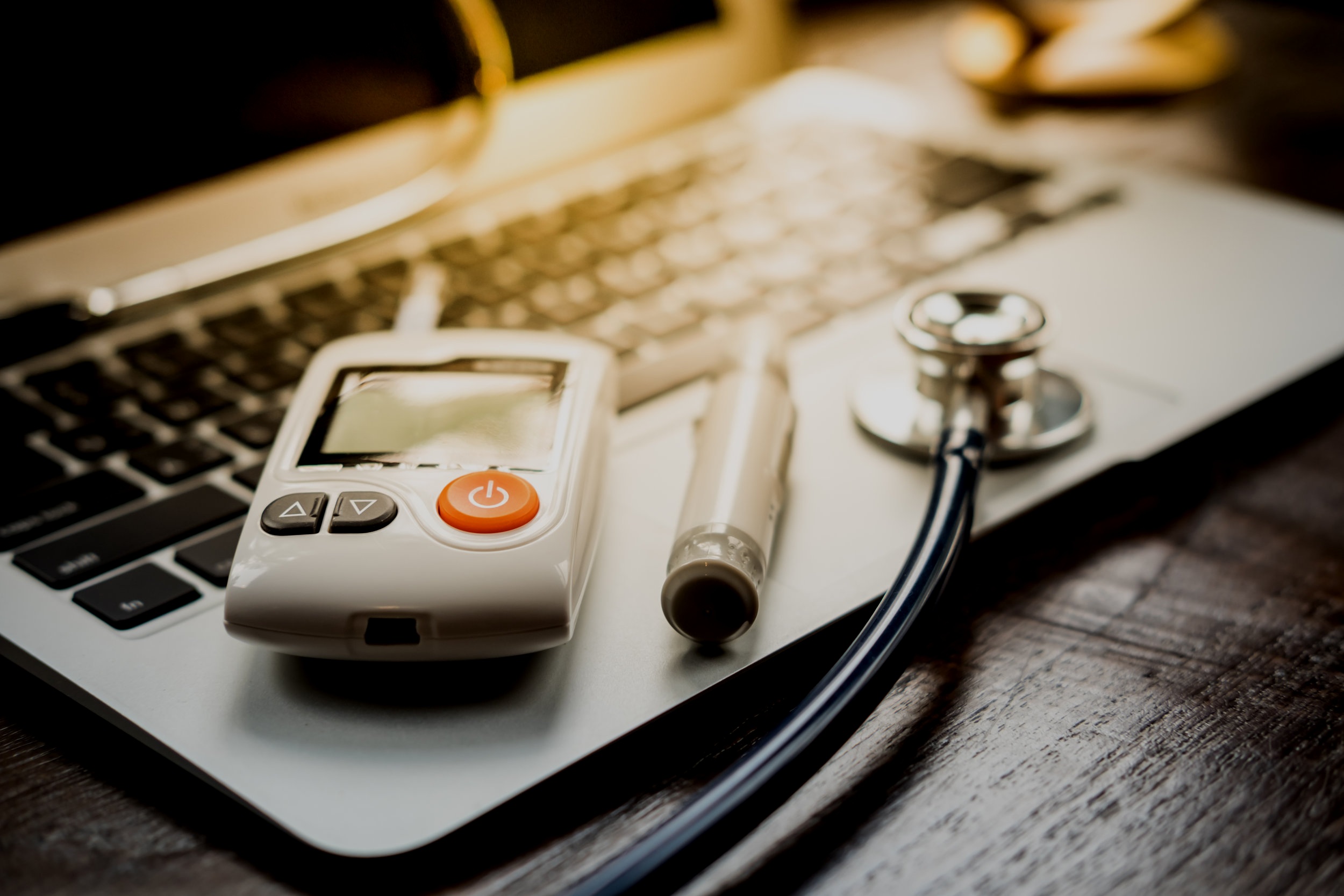 Technology+and+medicine+-+Silver+stethoscope+and+blood+glucose+meter+over+laptop+keyboard+%281%29.jpg
